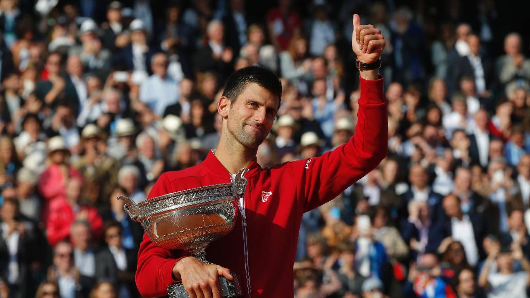 FILE - In this Sunday, June 5, 2016 file photo, Serbia's Novak Djokovic holds the trophy after winning the final of the French Open tennis tournament against Britain's Andy Murray, at the Roland Garros stadium in Paris, France. Novak Djokovic on Friday, Sept. 30 says Grand Slam trophies and the No. 1 ranking are no longer his priority. The top-ranked Serb, who has won 12 major titles, says he felt emotionally drained after winning the French Open in June for his first Grand Slam title at Roland Garros and his fourth in a row. (AP Photo/Michel Euler, file)