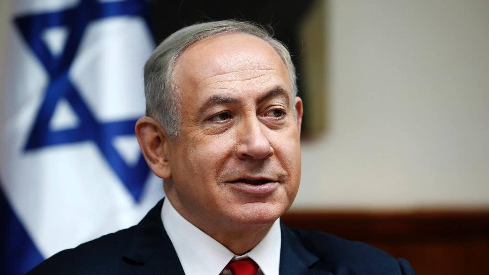 FILE - In this Sunday, Jan. 22, 2017, file photo, Israeli Prime Minister Benjamin Netanyahu attends the weekly cabinet meeting in Jerusalem. An Israeli newspaper quoted President Donald Trump on Friday, Feb. 10, as saying that settlement expansion in land claimed by the Palestinians does not advance peace indicating there might be some difficult discussions on the topic at the heart of the conflict in a high profile White House meeting with Netanyahu next week. (Ronen Zvulun/Pool Photo via AP, File)