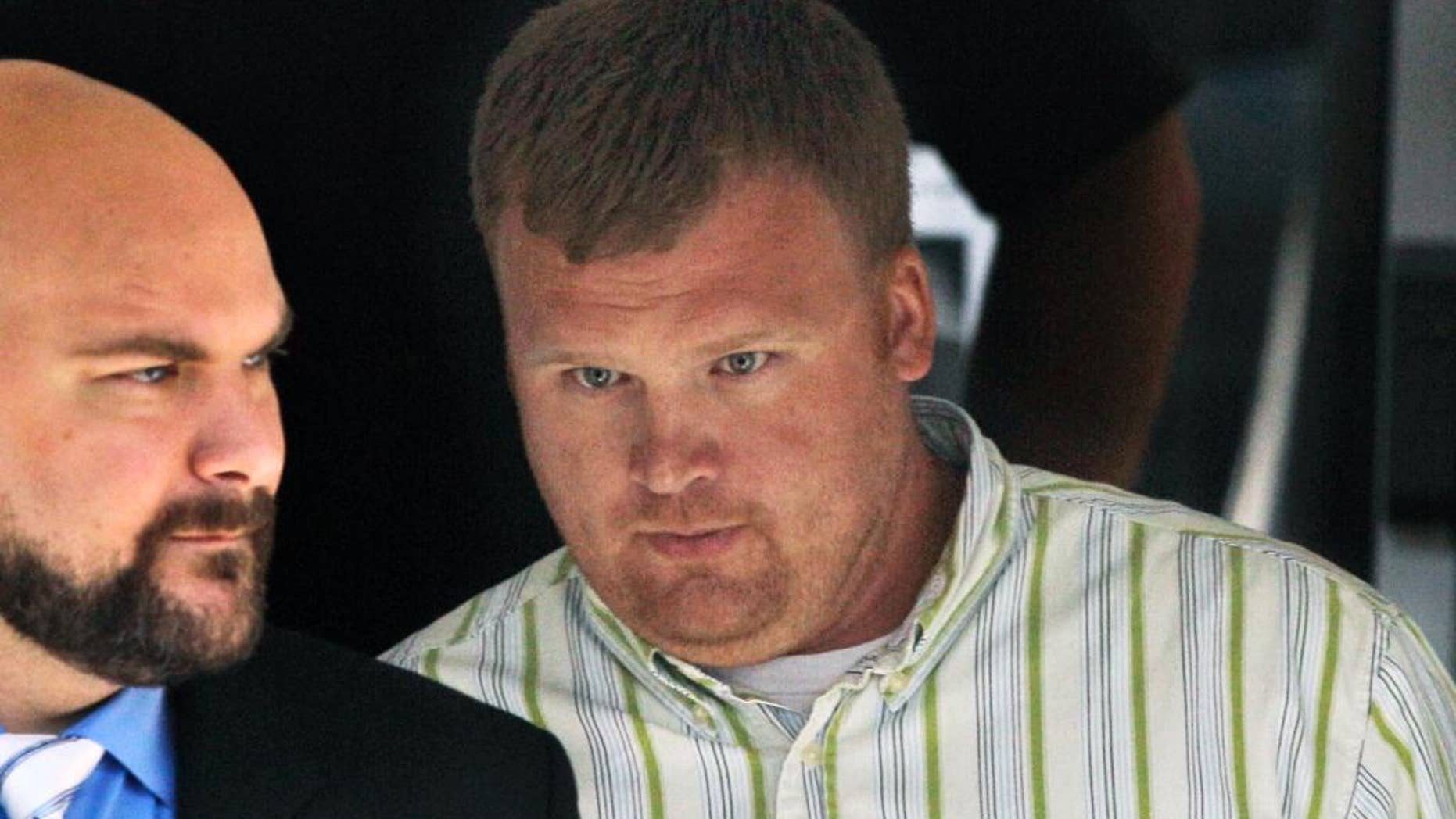 FILE - In this June 20, 2012, file photo, Matt Sandusky, right, adopted son of former Penn State assistant coach Jerry Sandusky, leaves the Centre County Courthouse in Bellefonte, Pa., where his father was being tried on charges of child sexual abuse involving 10 boys over a period of 15 years. Matt Sandusky spoke out Friday, Dec. 5, 2014, about his two abusive fathers and called sexual abuse the "single worst health epidemic that children face." (AP Photo/Gene J. Puskar, File)