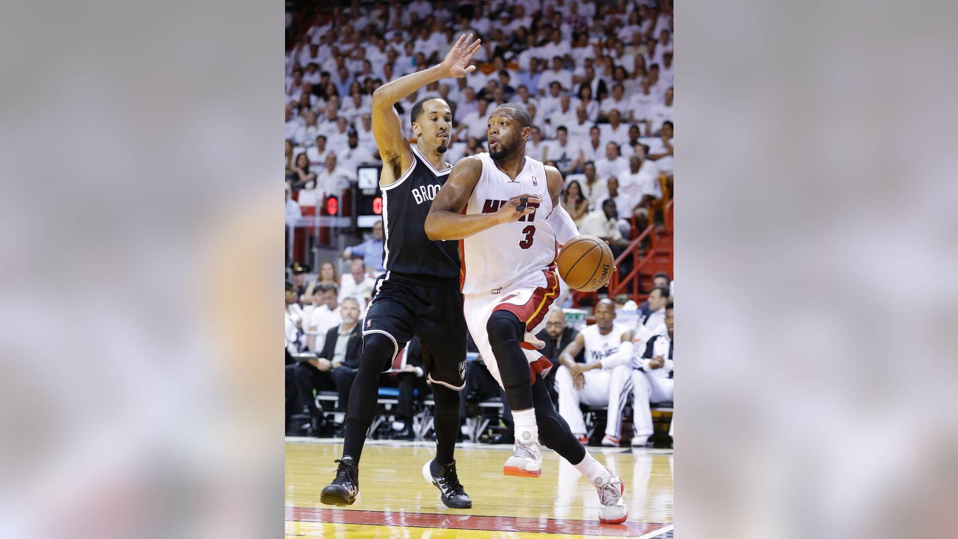 Miami Heat guard Dwyane Wade (3) drives gainst Brooklyn Nets guard Shaun Livingston during the first half of Game 2 of an Eastern Conference semifinal NBA playoff basketball game, Thursday, May 8, 2014 in Miami. (AP Photo/Wilfredo Lee)