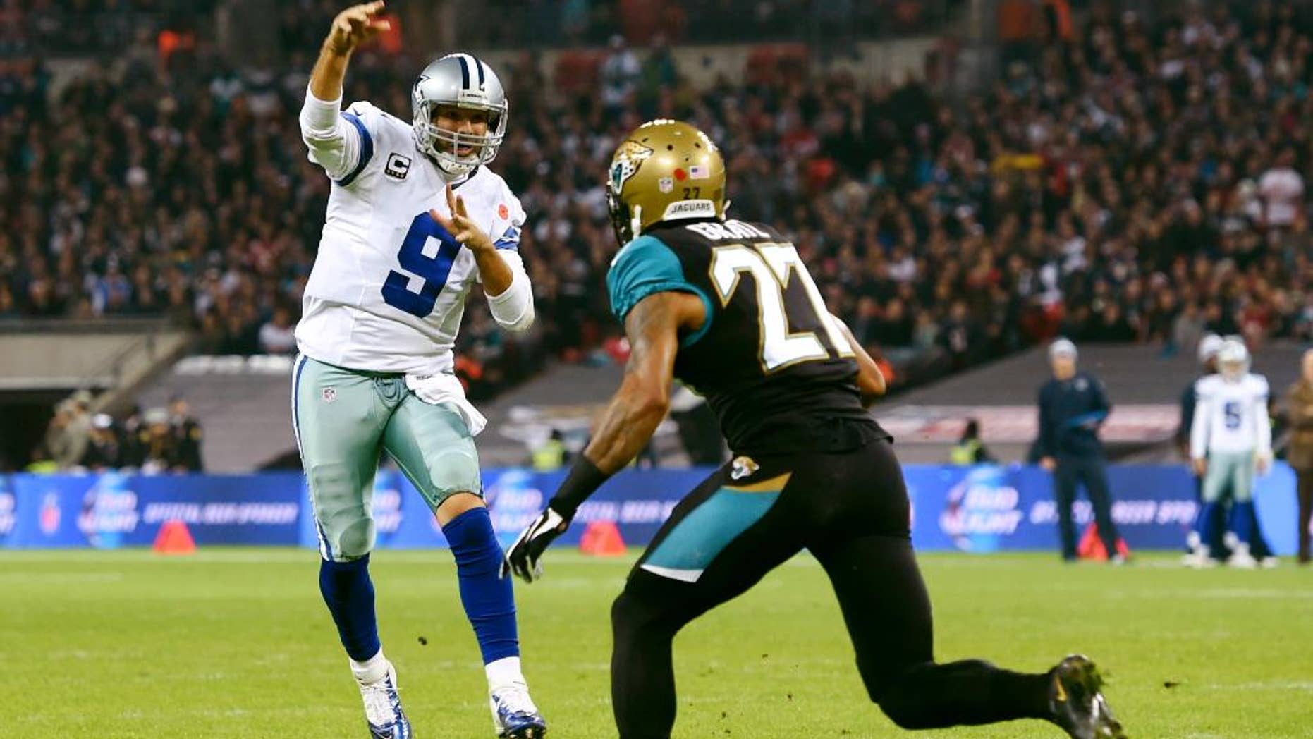 Jacksonville Jaguars wide receiver Cecil Shorts (84) is pursued by Dallas Cowboys defensive back Sterling Moore (26) and free safety J.J. Wilcox (27) during the first half of an NFL football game at Wembley Stadium, London, Sunday, Nov. 9, 2014. (AP Photo/Tim Ireland)