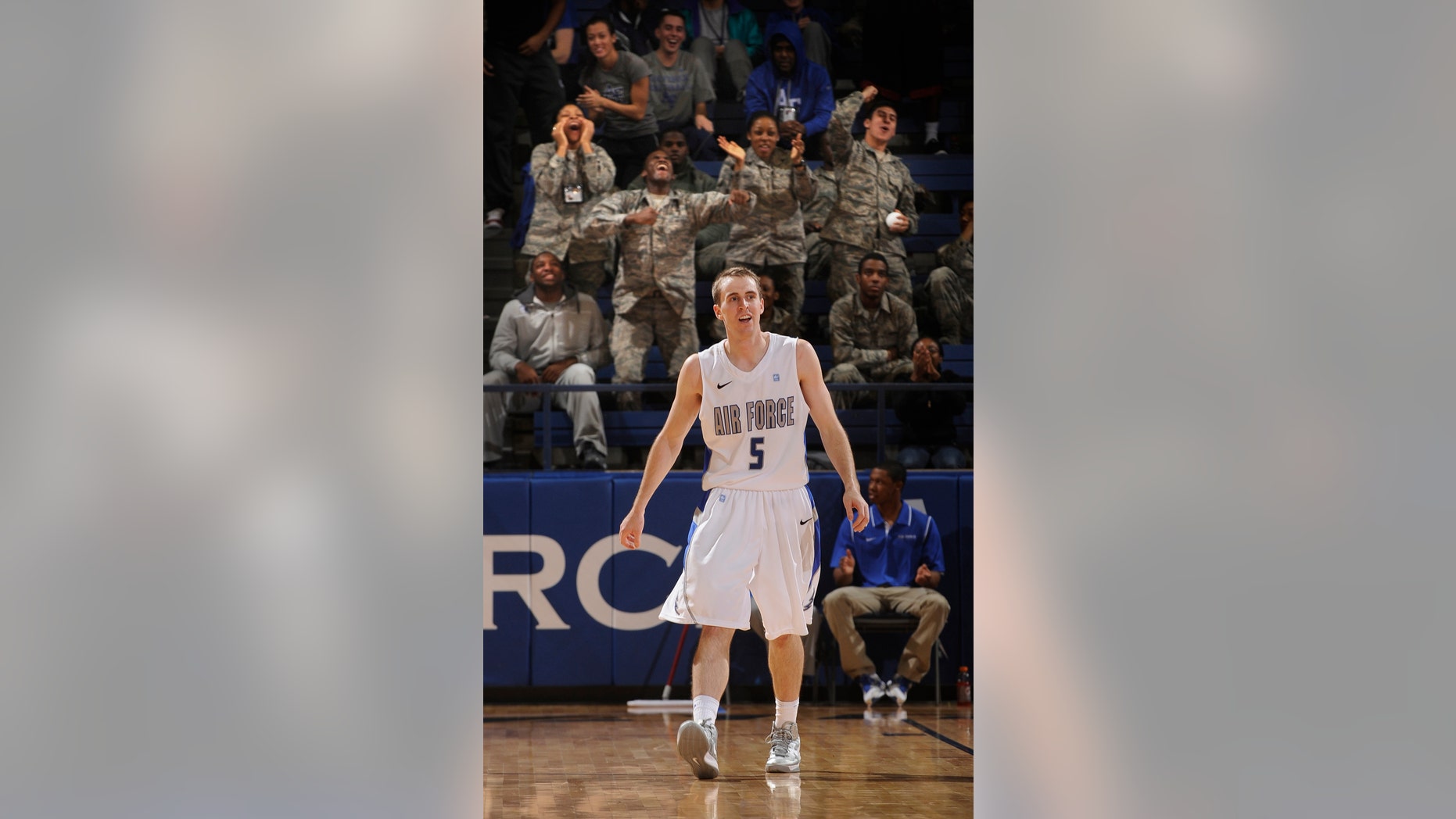 Fans celebrate behind Air Force's Mike Fitzgerald after his three-point basket in the second half of an NCAA college basketball game Nevada at Clune Arena in Air Force Academy, Colo., Wednesday, Jan. 9, 2013. Air Force went on to win 78-65 and Fitzgerald had 30 points for the day. (AP Photo/ The Gazette, Mark Reis) MAGAZINES OUT