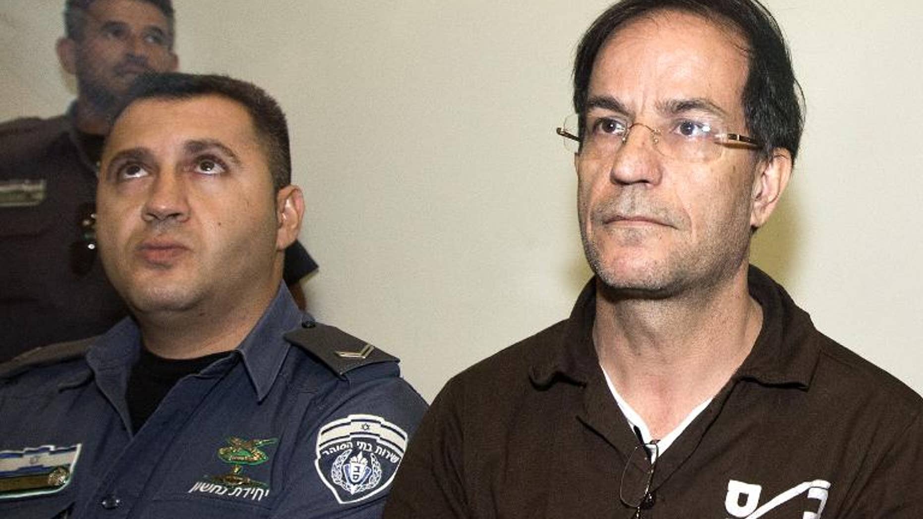 Ali Mansouri, 58, arrested at Israel's Ben Gurion Airport on suspicion of espionage, arrives at the Petah Tikva District Court on the first day of his trial on September 30, 2013