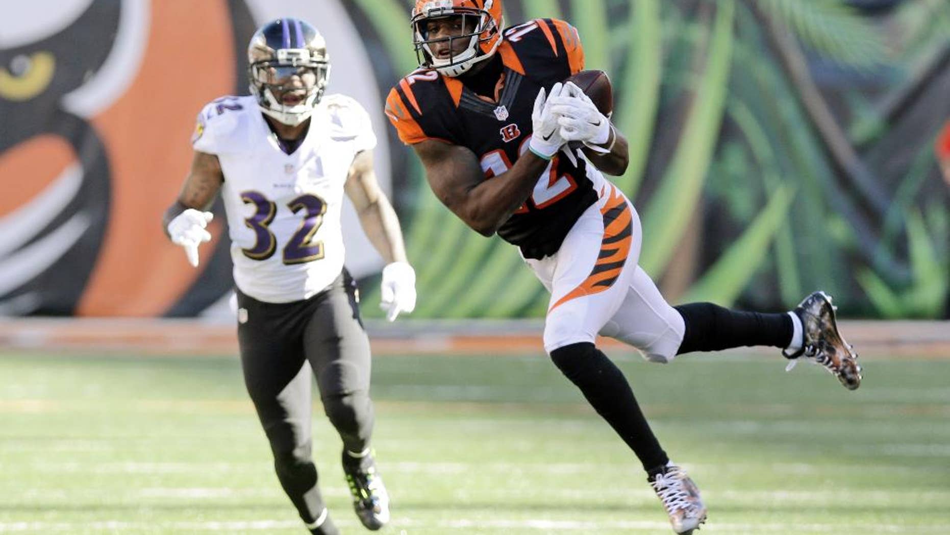 Cincinnati Bengals wide receiver Mohamed Sanu makes a catch in front of Baltimore Ravens defensive back Dominique Franks on the Bengals final drives during the second half of an NFL football game in Cincinnati, Sunday, Oct. 26, 2014. (AP Photo/Al Behrman)