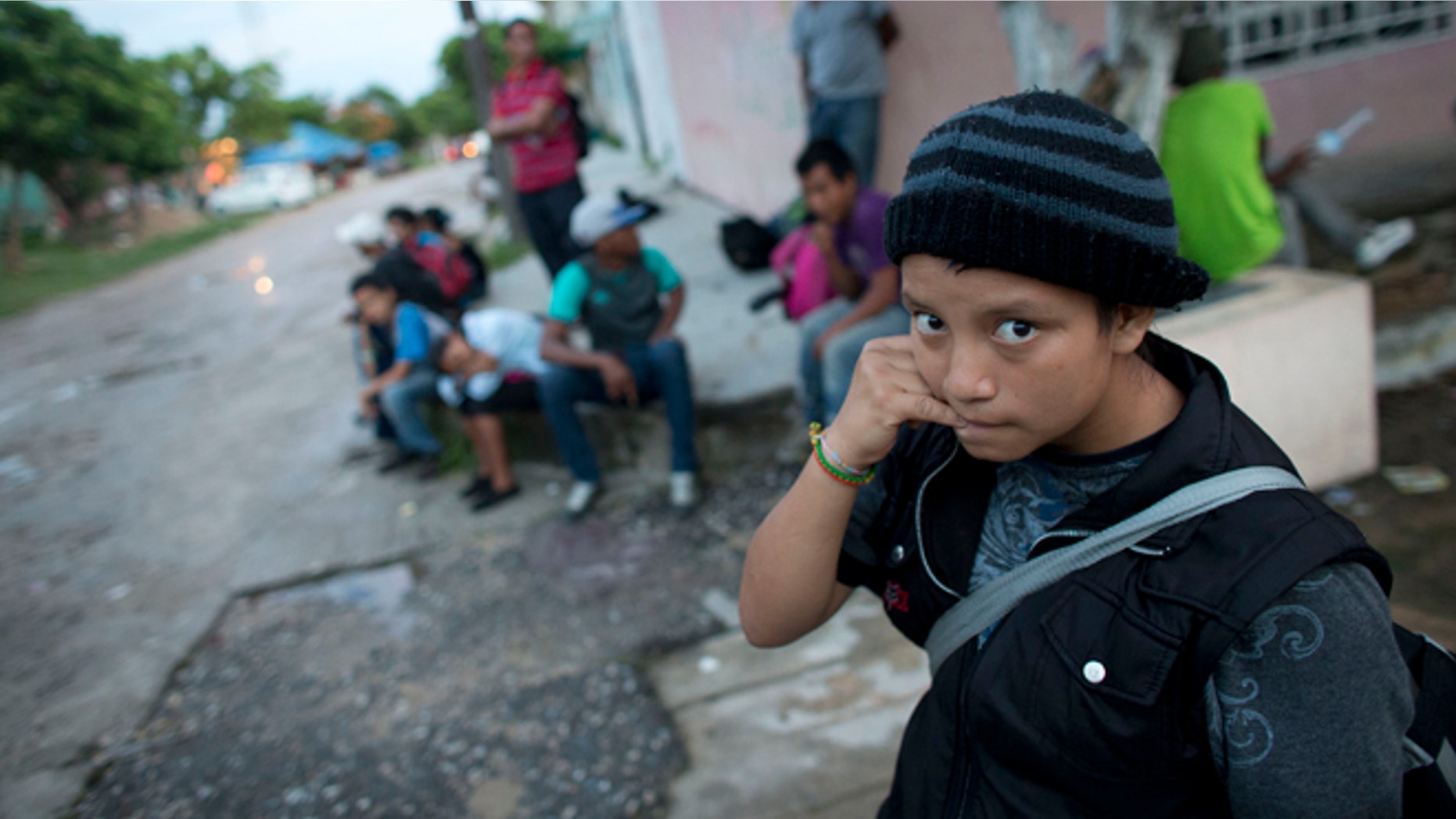 In this June 19, 2014 photo, a 14-year-old Guatemalan girl traveling alone waits for a northbound freight train along with other Central American migrants, in Arriaga, Chiapas state, Mexico. The United States has seen a dramatic increase in the number of Central American migrants crossing into its territory, particularly children traveling without any adult guardian. More than 52,000 unaccompanied children have been apprehended since October. (AP Photo/Rebecca Blackwell)