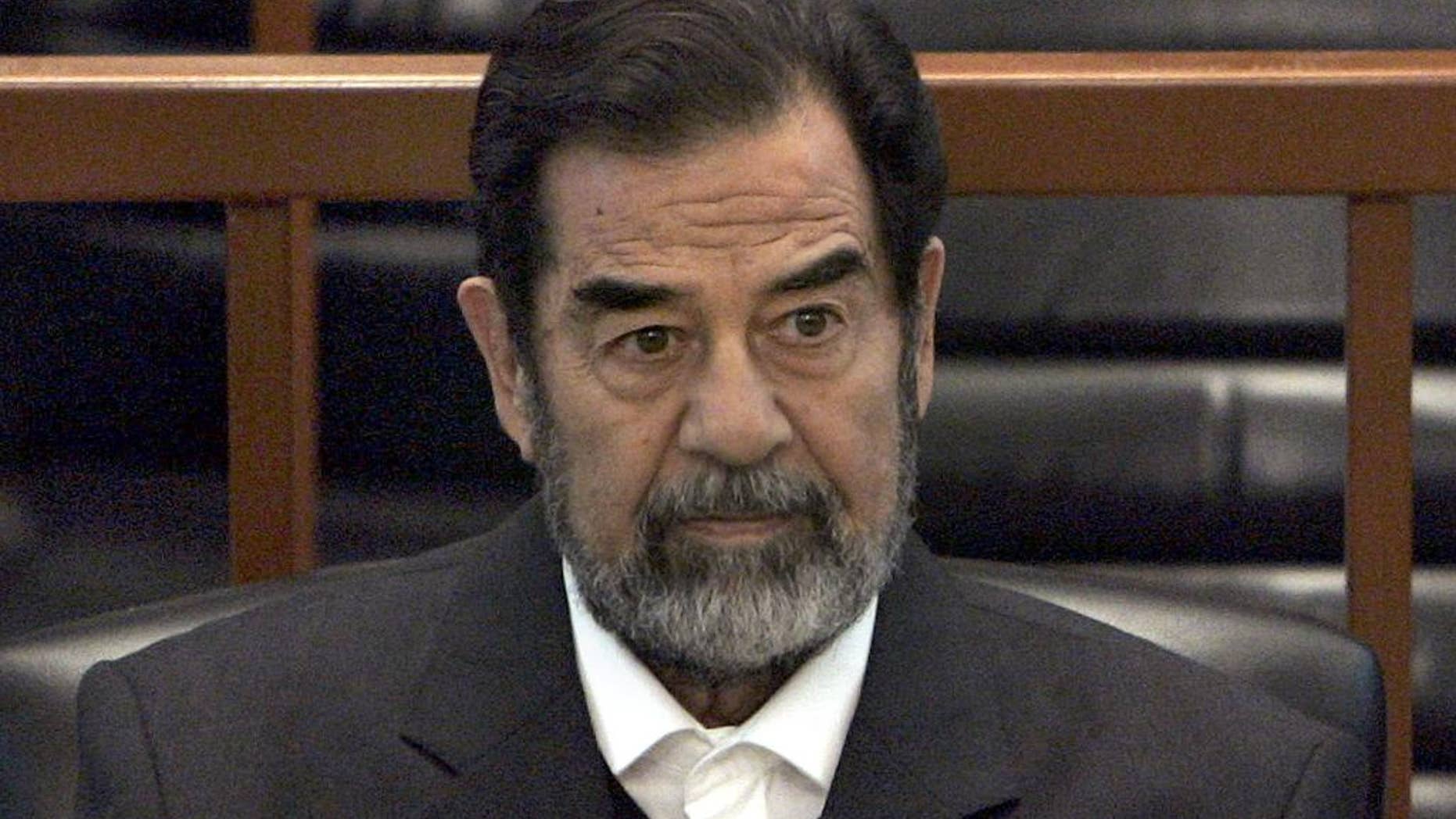 FILE - In this Dec. 6, 2006 file photo, former Iraq leader Saddam Hussein sits in court in Baghdad, Iraq, during the "Anfal" trial against him. Republican Donald Trump is again praising the former Iraqi President Hussein's ruthlessness, saying he killed terrorists "so good." Trump was speaking at a rally Tuesday, July 5, 2016, in North Carolina when he turned to the former Iraqi leader. (AP Photo/Chris Hondros, Pool, File)