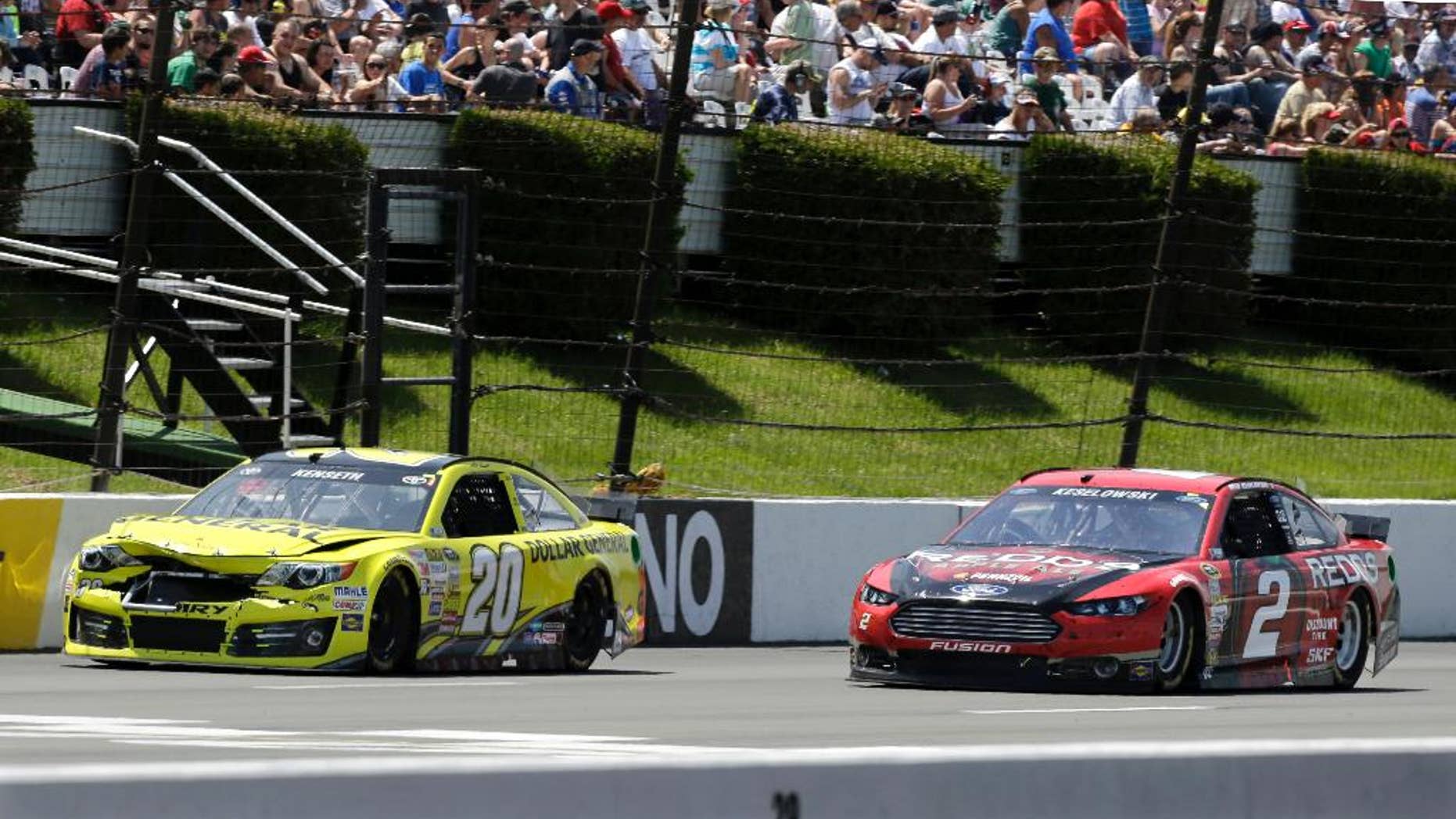 Driver Brad Keselowski (2) passes a damaged Matt Kenseth (20) during the NASCAR Sprint Cup series Pocono 400 auto race, Sunday, June 8, 2014, in Long Pond, Pa. (AP Photo/Mel Evans)