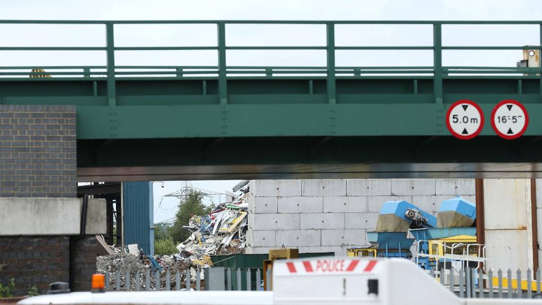 The scene at Hawkeswood Metal Recycling in the Nechells area of Birmingham where five men died after a wall collapsed, Thursday July 7, 2016. A sixth man was taken to a local hospital with leg injuries that were not said to be life-threatening. Police said the men were foreign nationals originally from Africa. (Chris Radburn/PA via AP)