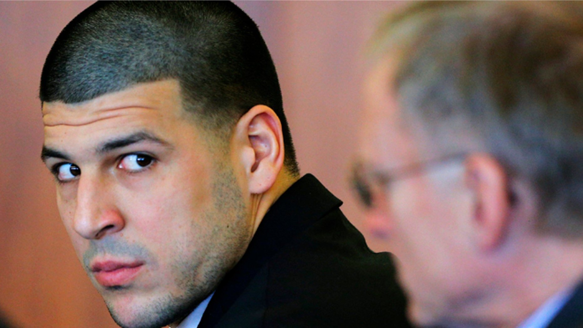 FILE - In this Dec. 22, 2014 file photo, former New England Patriots tight end Aaron Hernandez, left, attends a pretrial hearing in Fall River, Mass. Hernandez is accused of murdering semi-professional football player Odin Lloyd. A jury is expected to be seated for opening arguments in his murder trial as early as Tuesday, Jan. 27, 2015. Judge Susan Garsh had cleared 53 potential jurors after individually questioning them to weed out people who are biased, have a hardship or have a valid reason to be excused. Lawyers from both sides will have the chance to eliminate 18 people each from the final pool on Monday for any reason. Eighteen jurors will be seated. (AP Photo/Brian Snyder, Pool, File)