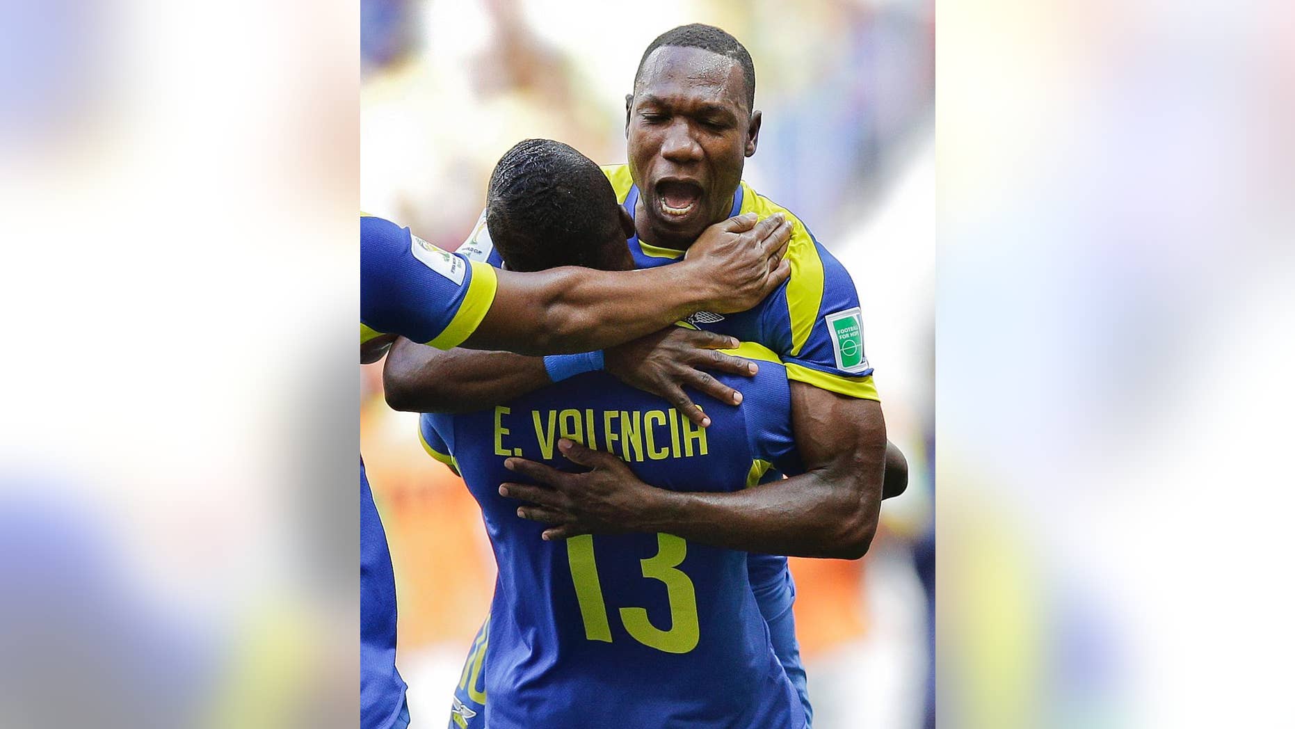 Ecuador's Walter Ayovi celebrates with opening goal scorer Enner Valencia (13) during the group E World Cup soccer match between Switzerland and Ecuador at the Estadio Nacional in Brasilia, Brazil, Sunday, June 15, 2014. (AP Photo/Michael Sohn)