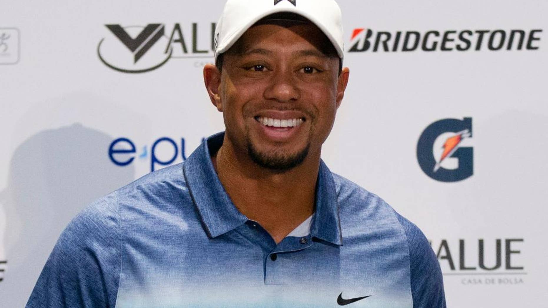 FILE - In this Oct. 20, 2015, file photo, Tiger Woods arrives for a press conference to launch Bridgestone America's Golf Cup in Mexico City. One tournament into his return was all Tiger Woods needed to strike a deal with Bridgestone to play its golf ball. Bridgestone Golf said Thursday, Dec. 15, 2016, it has signed Woods to a multi-year agreement in which he will play and promote the golf ball. (AP Photo/Rebecca Blackwell, File)