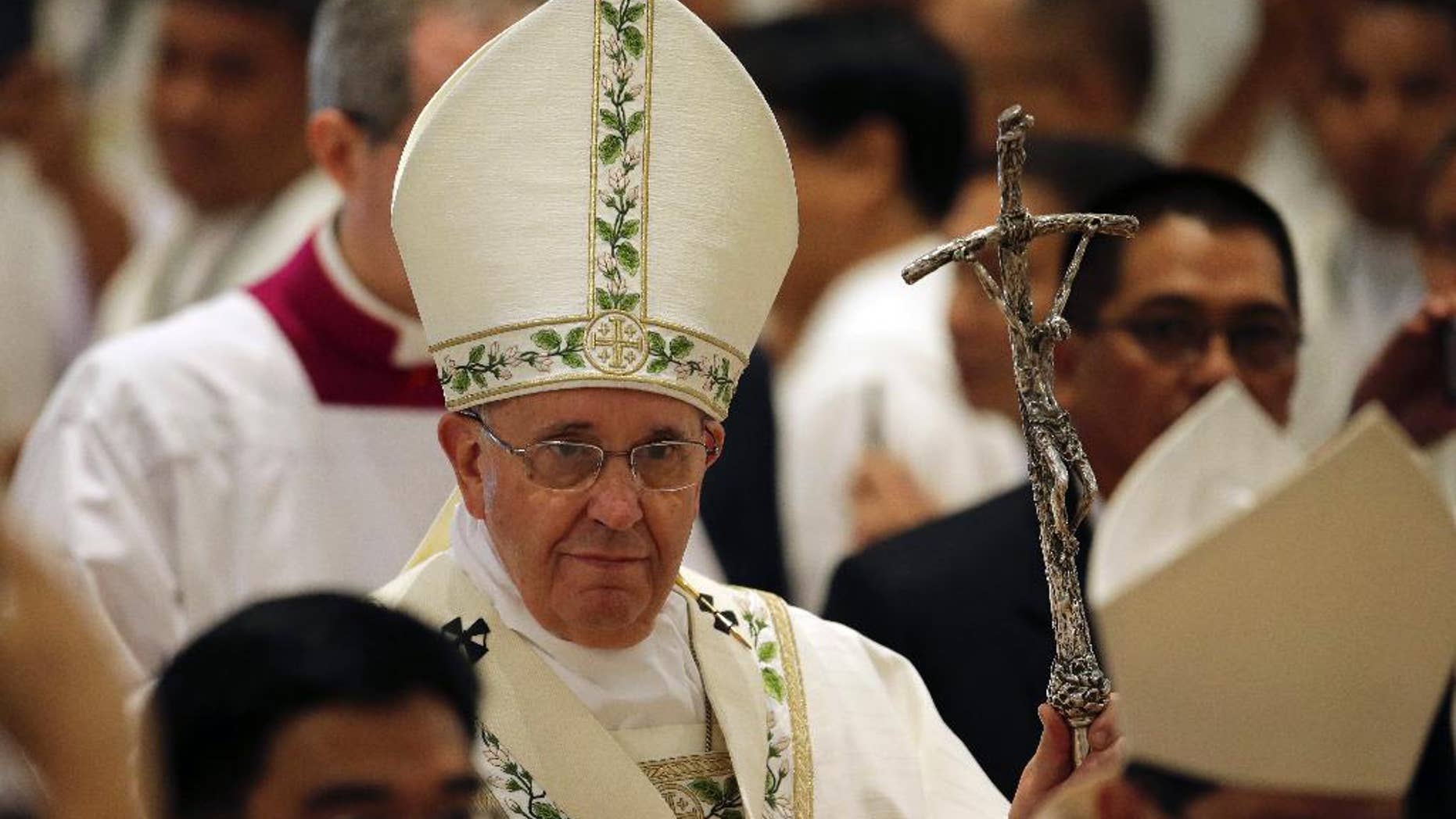 Pope Francis arrives for a Mass for the clergy and religious at the Cathedral Basilica of the Immaculate Conception during his visit in Manila, Philippines on Friday, Jan. 16, 2015. (AP Photo/Aaron Favila)