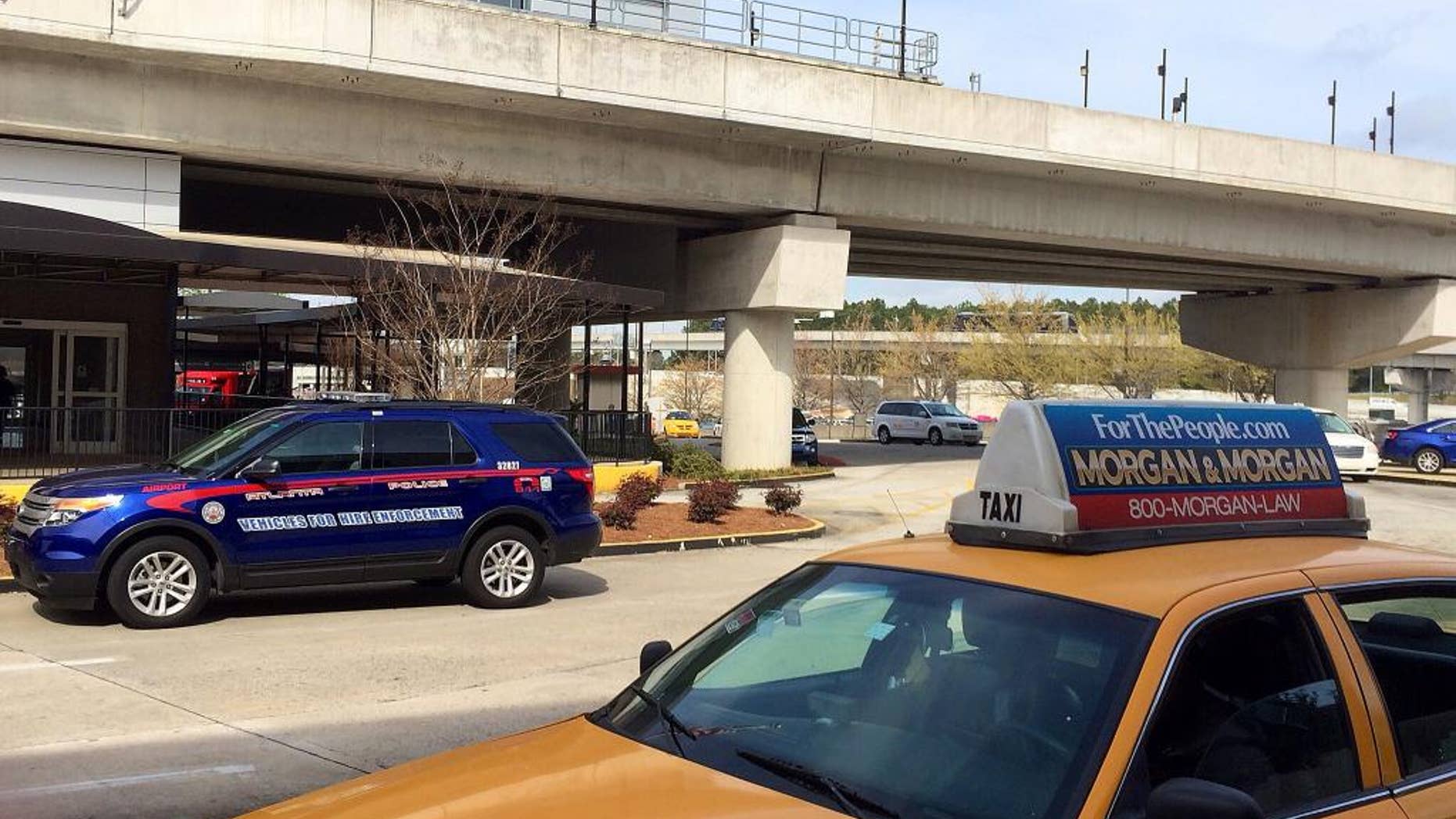March 25, 2016: n Atlanta Police Rides-For-Hire Enforcement vehicle sits amid taxi cabs outside the departures area of the domestic terminal at Hartsfield-Jackson Atlanta International Airport.