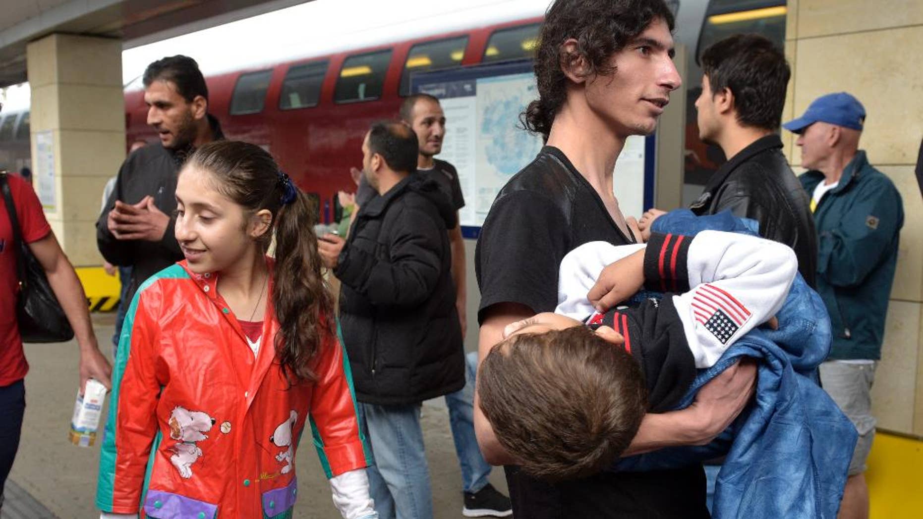 Migrants arrive at the Westbahnhof station in Vienna, Austria, Saturday, Sept. 5, 2015, where they came from Hungary as Austria in the early-morning hours said it and Germany would let them in. (AP Photo/Hans Punz)