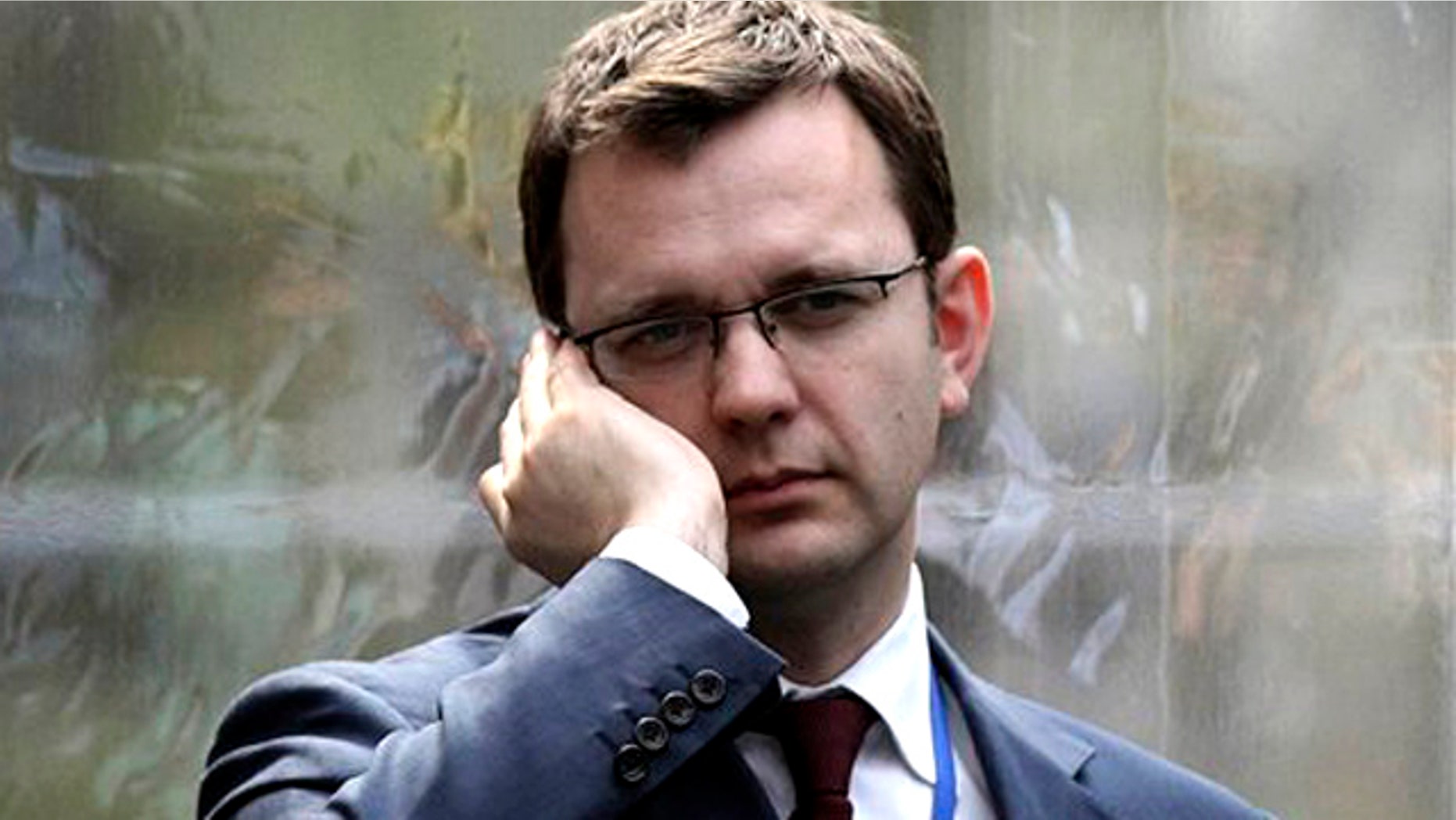 In this April 13, 2010 file photo, Andy Coulson, formerly editor of the tabloid News of the World, and later David Cameron's director of communications, speaks on a mobile phone in London