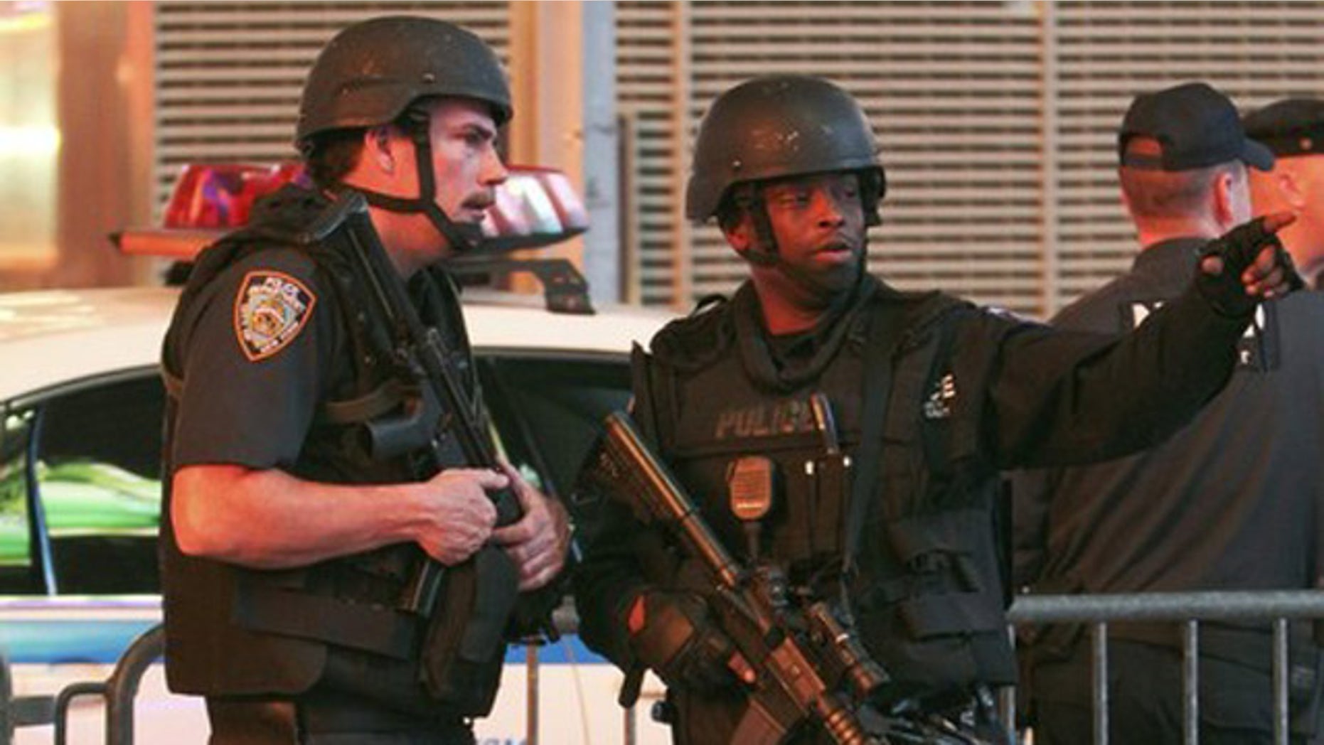 May 1: Armed NYPD officers talk to each other as police and fire personnel close off the area in New York's Times Square.