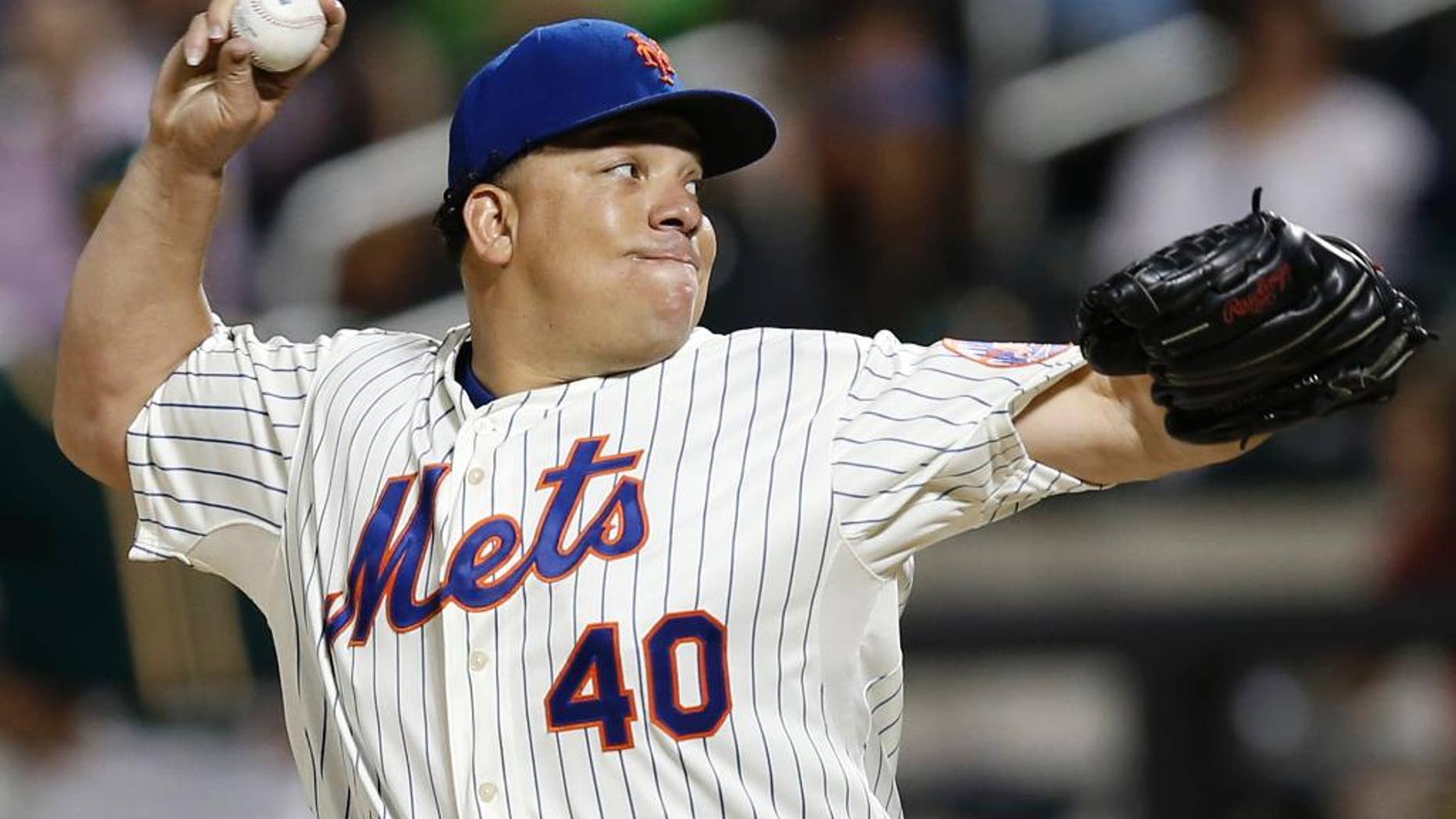 New York Mets starting pitcher Bartolo Colon delivers in the sixth inning of an interleague baseball game against the Oakland Athletics in New York, Tuesday, June 24, 2014. (AP Photo/Kathy Willens)