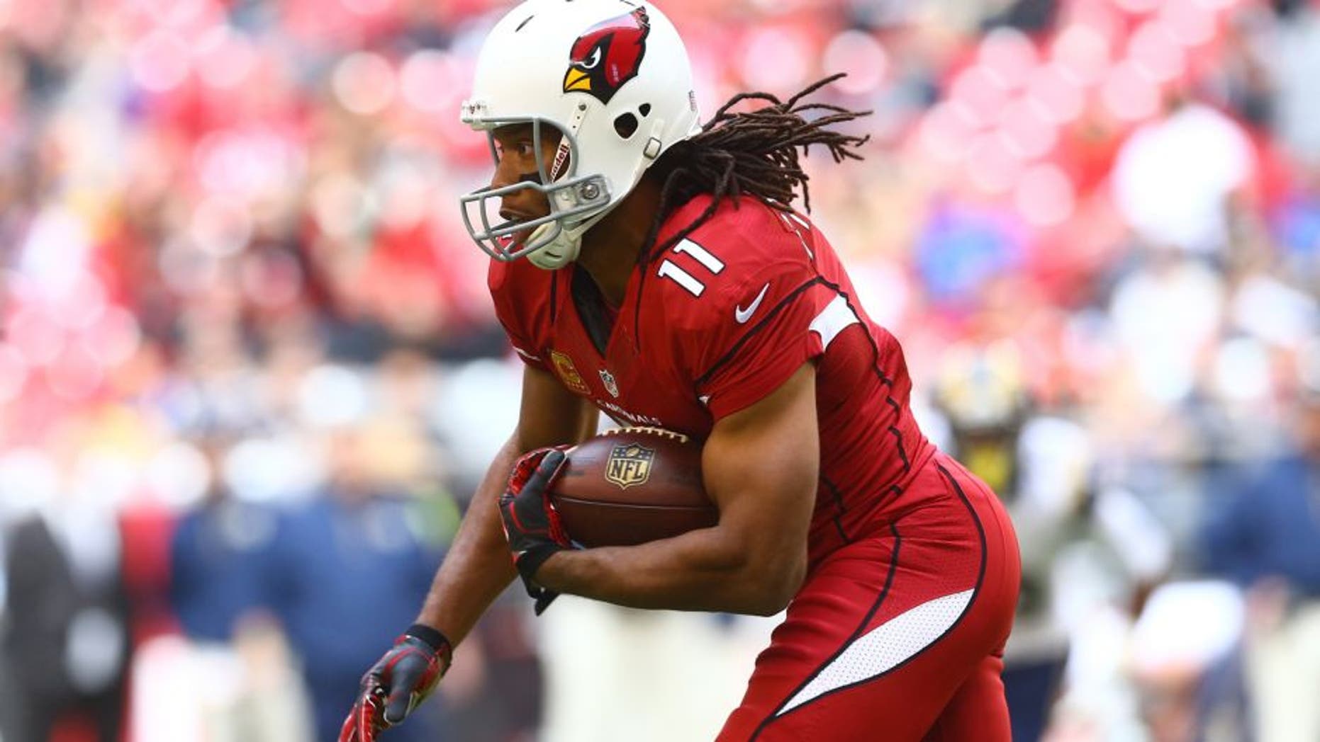 Dec 8, 2013; Phoenix, AZ, USA; Arizona Cardinals wide receiver Larry Fitzgerald (11) runs the ball in the first quarter against the St. Louis Rams at University of Phoenix Stadium. Mandatory Credit: Mark J. Rebilas-USA TODAY Sports