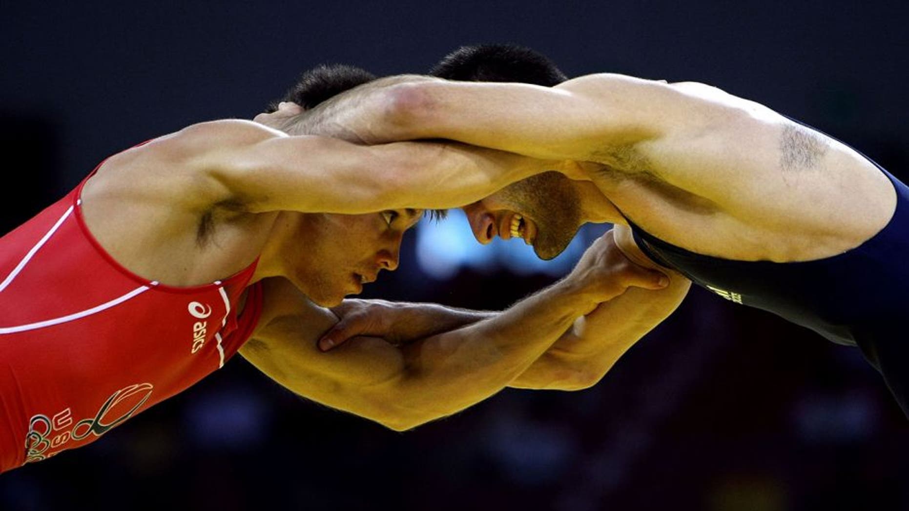 BEIJING - AUGUST 19: Henry Cejudo (red) of the United States competes against Besarion Gochashvili of Georgia during the 55kg freestyle wrestling event at the China Agriculture University Gymnasium on Day 11 of the Beijing 2008 Olympic Games on August 19, 2008 in Beijing, China. (Photo by Jed Jacobsohn/Getty Images)