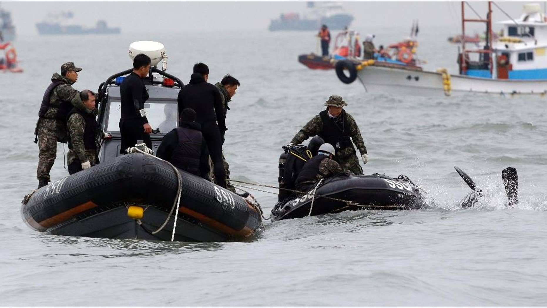 South Korean navy's frogman dives into a water to search passengers believed to have been trapped in the sunken ferry Sewol in the water off the southern coast near Jindo, south of Seoul, South Korea, Saturday, April 19, 2014. The captain of the sunken South Korean ferry was arrested Saturday on suspicion of negligence and abandoning people in need, as investigators looked into whether his evacuation order came too late to save lives. Two crew members were also arrested, a prosecutor said. (AP Photo/Lee Jin-man)