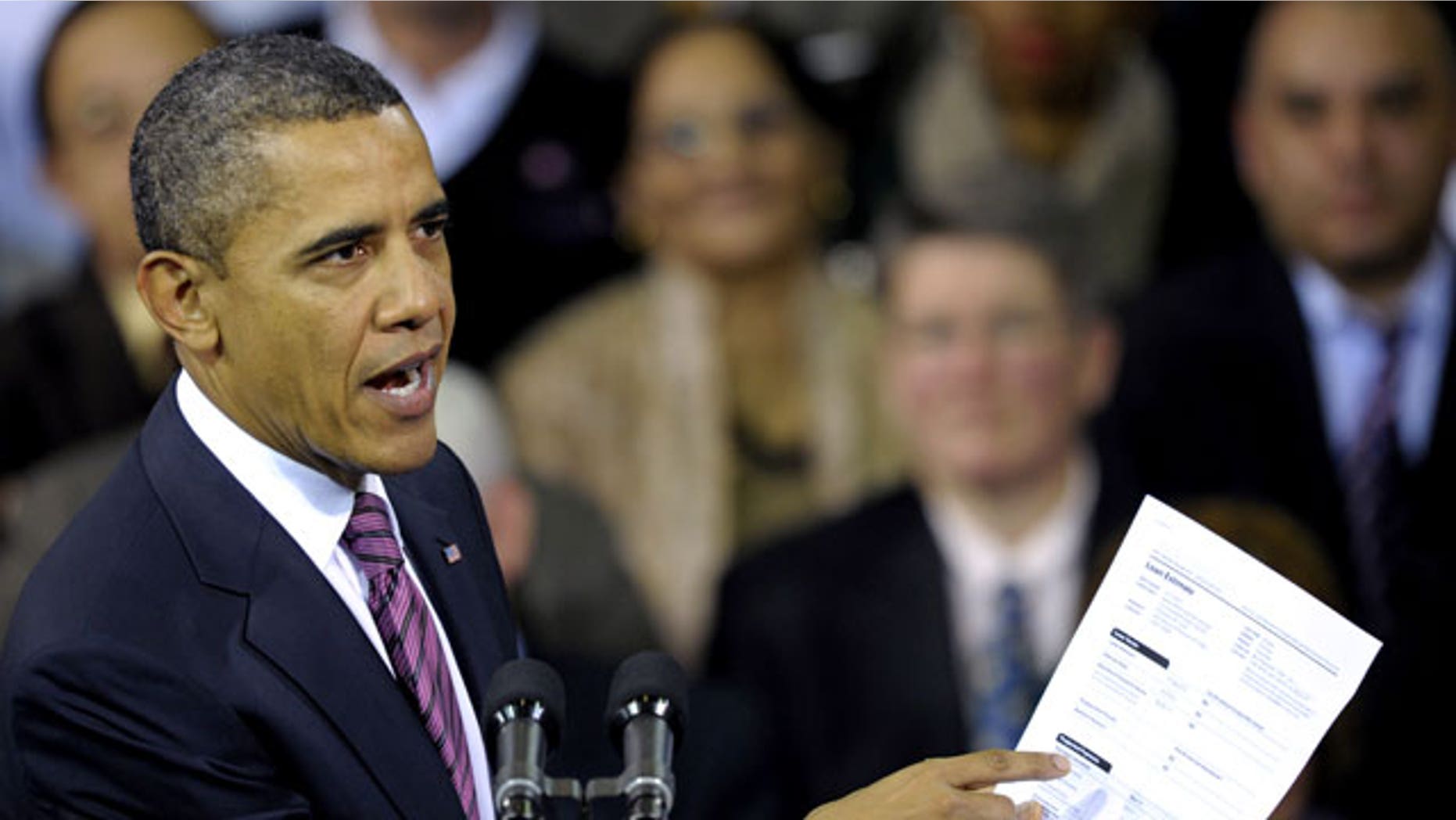 Feb. 1, 2012: President Barack Obama holds up a proposed mortgage application form as he speaks at the James Lee Community Center in Falls Church, Va.