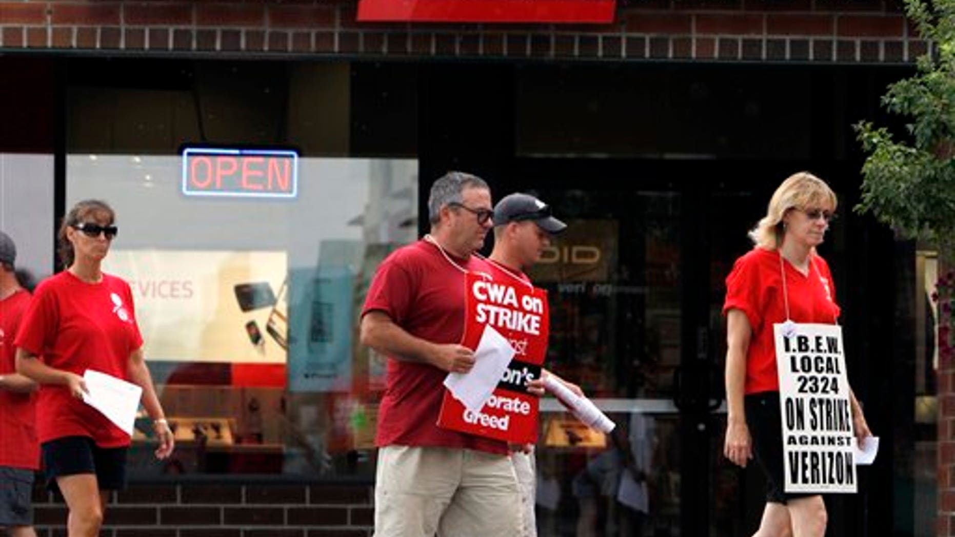 August 8: Striking Verizon workers picket in front of a Verizon Wireless store in Colonie, N.Y.