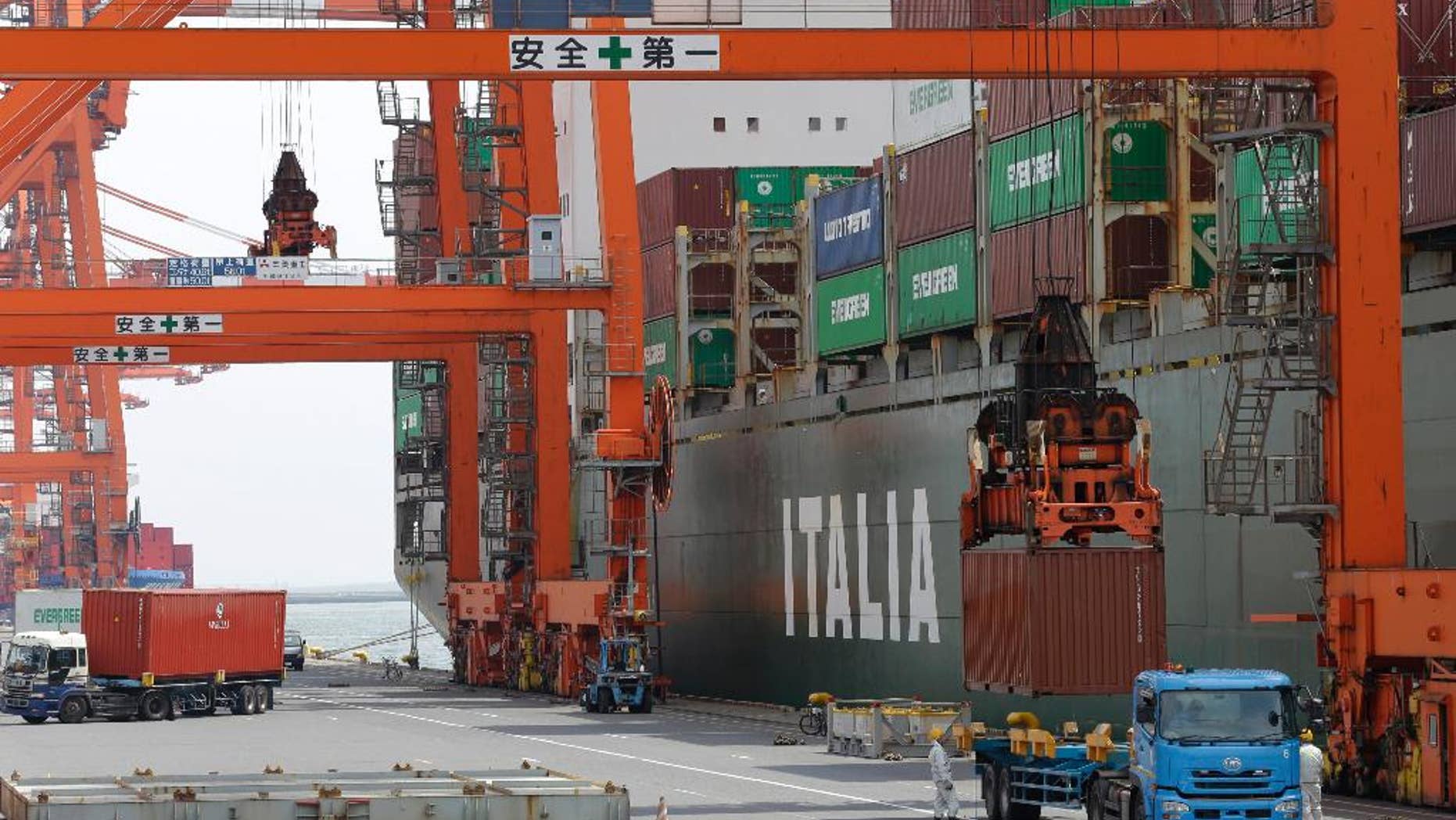 FILE - In this April 22, 2015 file photo, a cargo is loaded onto a truck at a port in Tokyo. Japan says its economy contracted at a 1.6 percent annual pace in the April-June quarter, as bad weather and slowing growth in China weakened demand. The gloomy preliminary growth data reported Monday, Aug. 17, 2015 was in line with expectations, though economists say that the longer term outlook is still positive. (AP Photo/Shizuo Kambayashi)