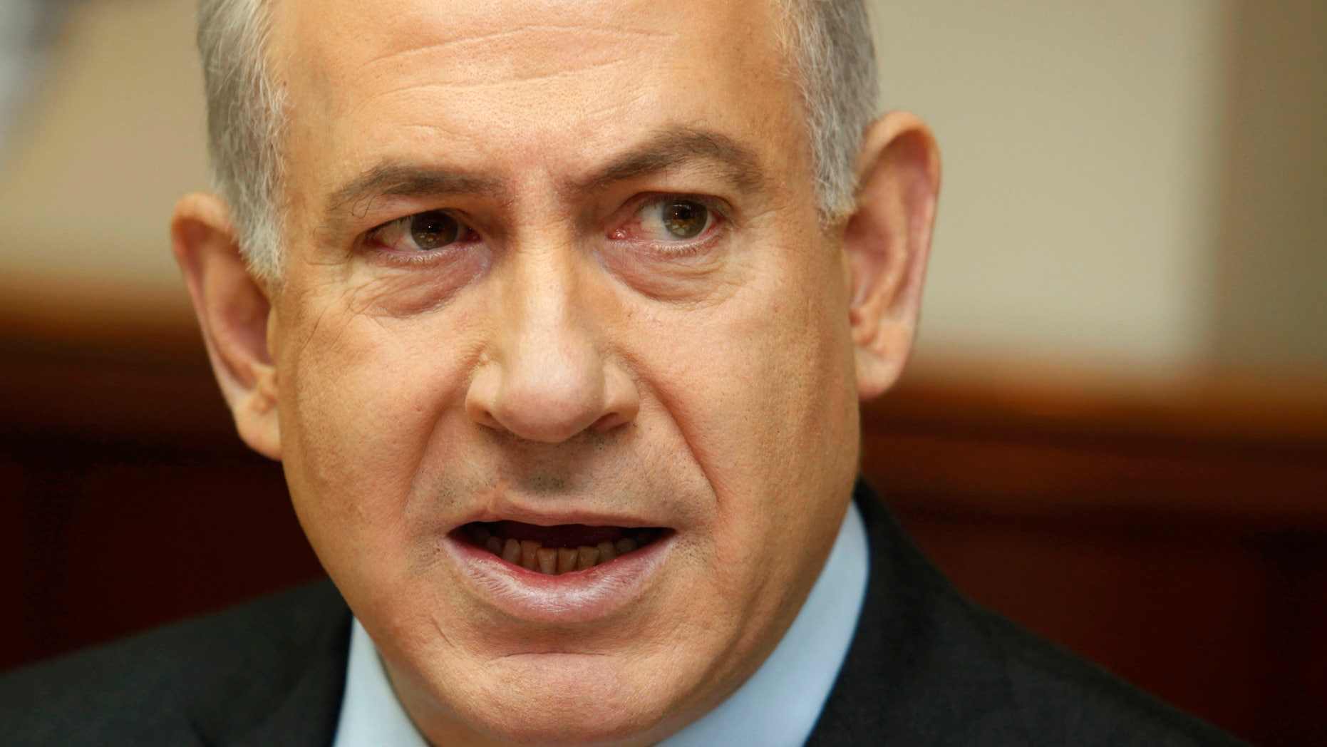 FILE - In this Dec. 16, 2012 file photo, Israeli Prime Minister Benjamin Netanyahu attends the weekly cabinet meeting in his Jerusalem office. Netanyahu’s decision to bring a dovish rival into his Cabinet appears to be backfiring, drawing heavy criticism both in Israel and from the Palestinians and suddenly complicating the task of forming a viable coalition government. It is now uncertain whether Netanyahu will meet an initial deadline next week for forming a new coalition, and rivals are openly talking about the possibility of forcing new elections, just a month after a parliamentary election ended in virtual deadlock. (AP Photo/Gali Tibbon, Pool, File)