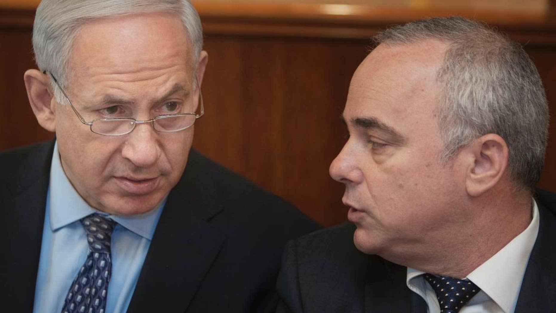 FILE - In this Monday, July 30, 2012 file photo, Israeli Prime Minister Benjamin Netanyahu, left, sits together with Finance Minister Yuval Steinitz, as they attend the weekly cabinet meeting in his Jerusalem office. Steinitz on Monday said taking military action against Iran’s nuclear program is still an option, despite last week’s framework deal between world powers and the Islamic Republic. (AP Photo/Sebastian Scheiner, File)