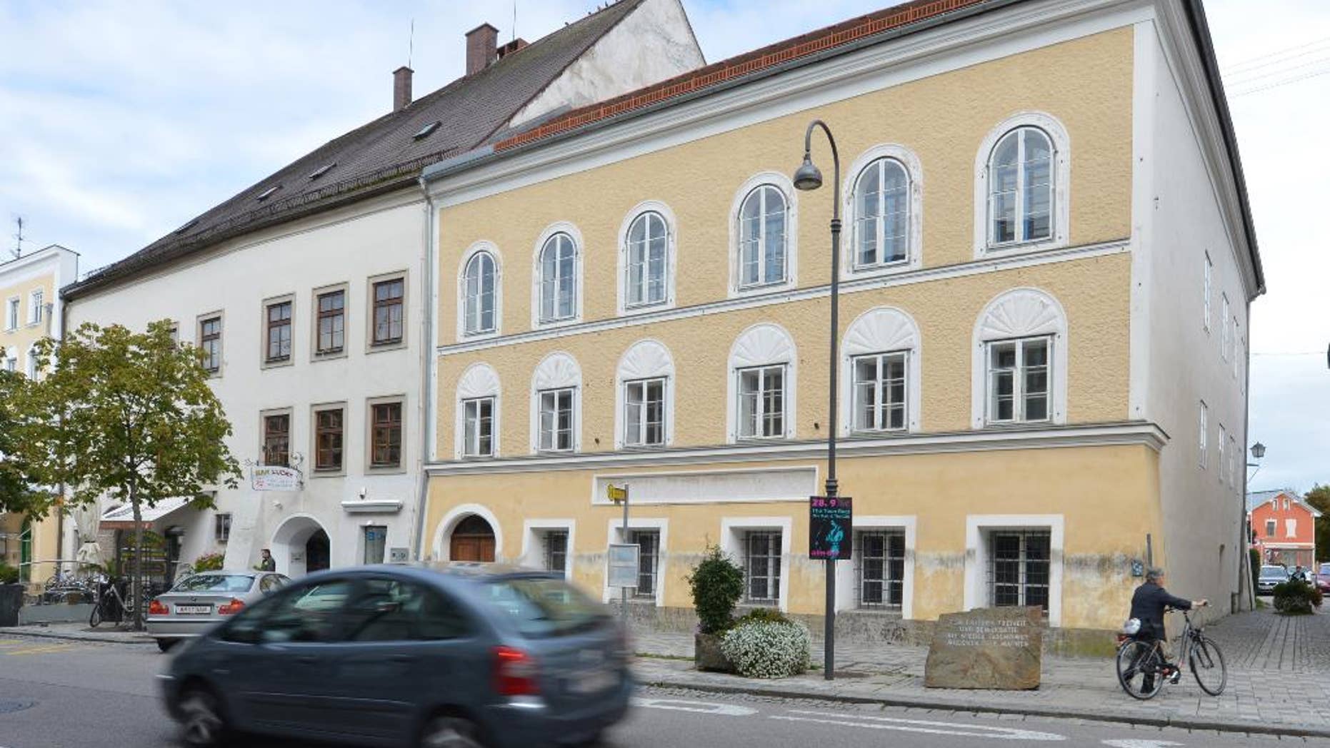 FILE - This Sept. 27, 2012 file picture shows an exterior view of Adolf Hitler's birth house , front, in Braunau am Inn, Austria. Austria’s interior minister says Saturday June 11, 2016 he can imagine having the house where Adolf Hitler was born demolished, calling it “the cleanest solution.” The Austrian government wants to expropriate the house in Braunau am Inn where the future Nazi leader was born in 1889 to keep it from falling into the wrong hands. (AP Photo / Kerstin Joensson)