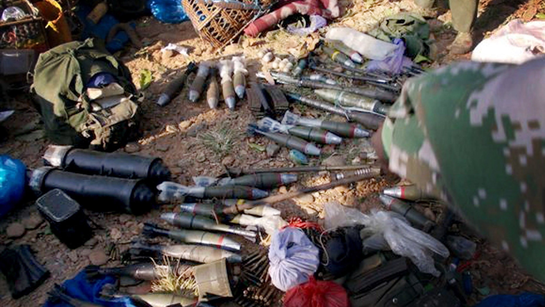 In this photo taken December 15, 2012, and released Monday, Jan. 7, 2013, by Free Burma Rangers, Kachin rebels display the ammunitions they seized from Myanmar soldiers in Laiza, northern Myanmar. Ethnic Kachin rebels in Myanmar accused government troops of launching two artillery attacks Sunday against the city that serves as their headquarters, but no casualties or significant damage were reported. (AP Photo/Free Burma Rangers)