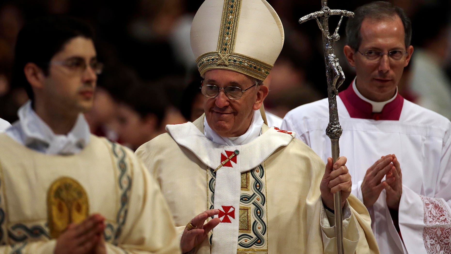 Pope Francis leaves at the end of a mass where he ordained ten new priests in St. Peter's Basilica at the Vatican, Sunday, April 21, 2013. (AP Photo/Gregorio Borgia)