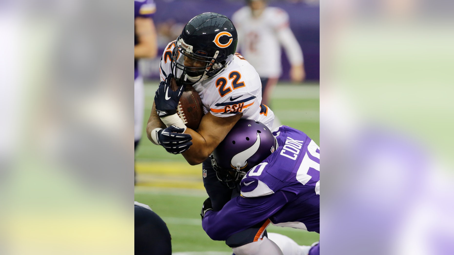 Chicago Bears running back Matt Forte (22) is tackled by Minnesota Vikings cornerback Chris Cook during the first half of an NFL football game on Sunday, Dec. 1, 2013, in Minneapolis. (AP Photo/Ann Heisenfelt)