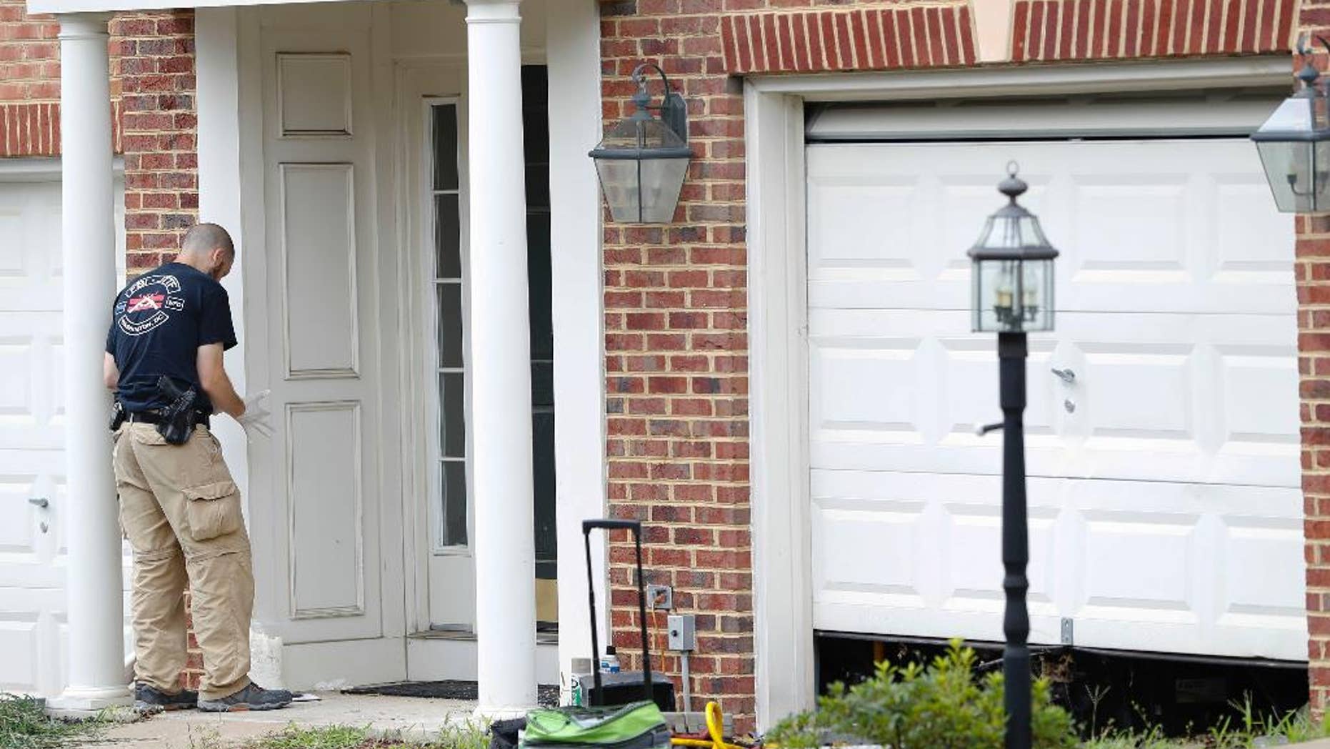 A law enforcement officer at Nicholas Young's home in August.