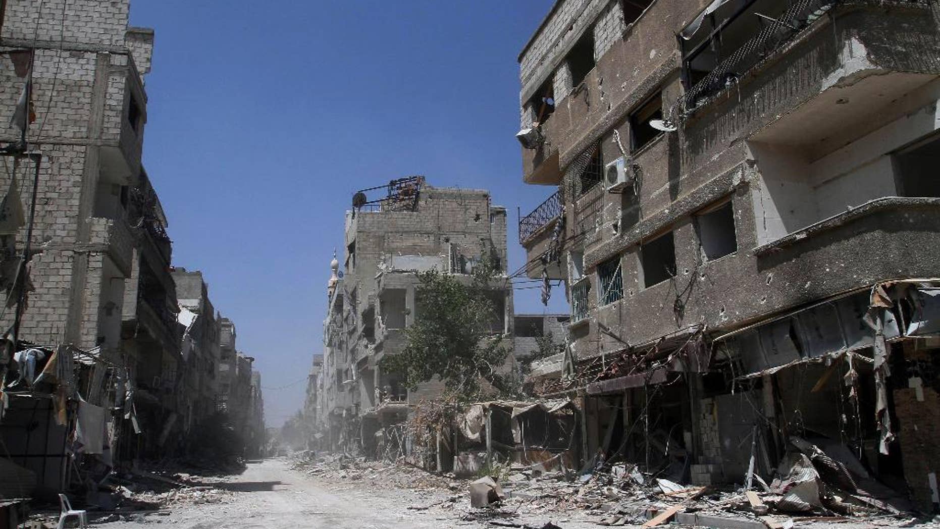 Aug. 15, 2014: In this photo taken during a Syrian government-led media tour, buildings damaged during battles between Syrian troops and rebels stand along an empty street in Mleiha, some 6 miles southeast of downtown Damascus, Syria. (AP)