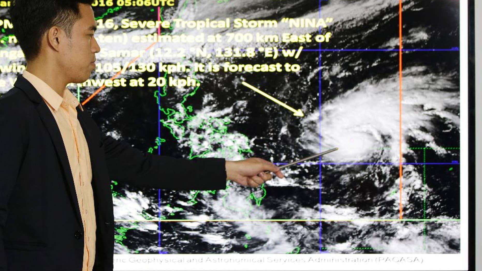 Weather specialist Benison Estareja shows the track of Tropical Storm Nock-Ten during a press conference in Quezon city, north of Manila, Philippines on Friday, Dec. 23, 2016. A severe tropical storm has gained strength as it moves closer to the Philippines and may intensify further into a typhoon, bringing moderate to heavy rains and blustery weather on Christmas Day, the biggest holiday in the predominantly Roman Catholic nation, weather forecasters said. (AP Photo/Aaron Favila)