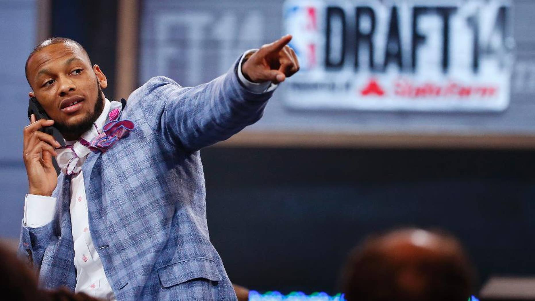 NBA draft prospect Adreian Payne of Michigan State, points to fans before the start of the 2014 NBA draft, Thursday, June 26, 2014, in New York. (AP Photo/Jason DeCrow)