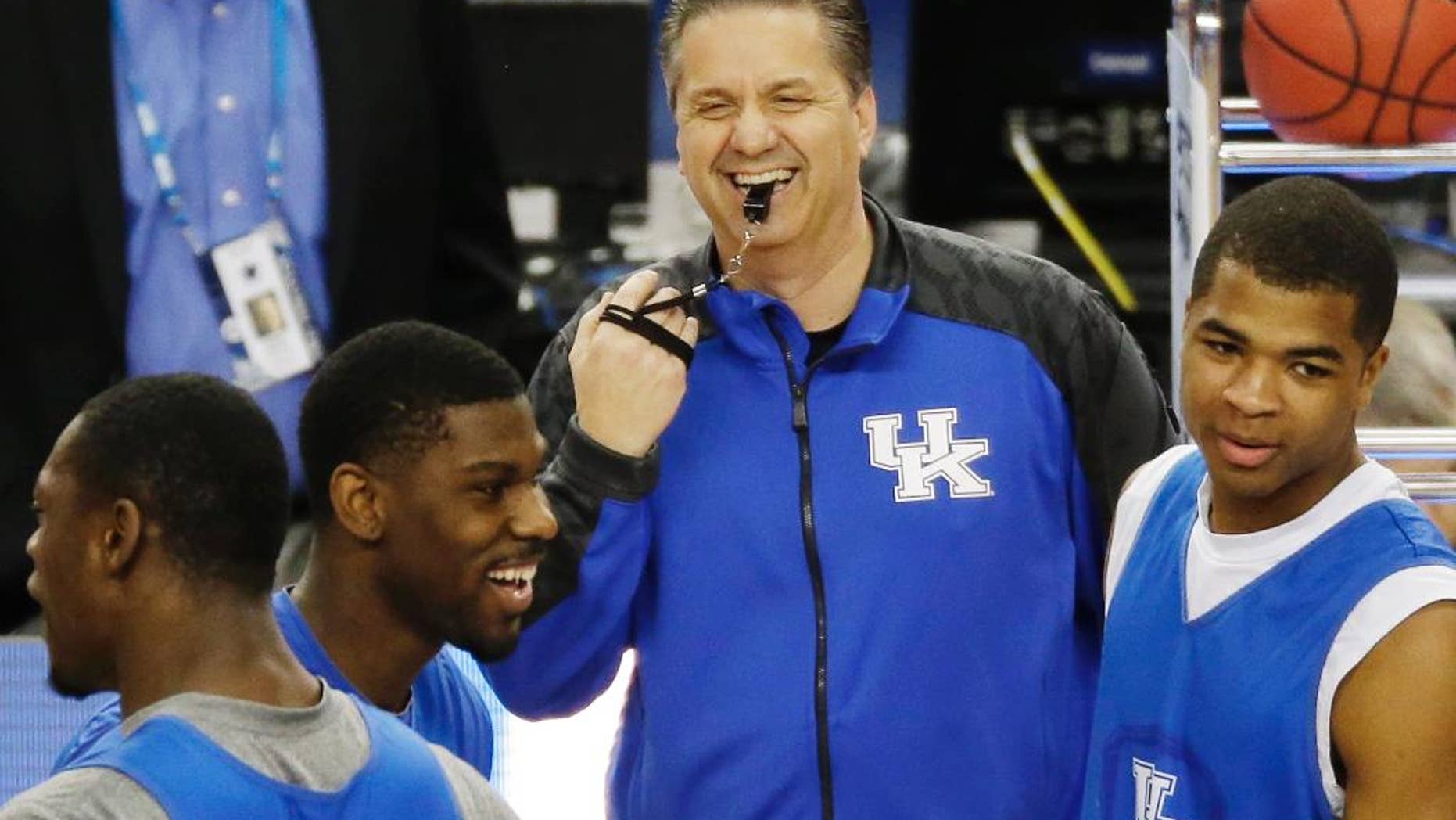 Kentucky head coach John Calipari shares a light moment with the team during practice for their NCAA Final Four tournament college basketball semifinal game Friday, April 4, 2014, in Dallas. Kentucky plays Wisconsin on Saturday, April 5, 2014. (AP Photo/Tony Gutierrez)