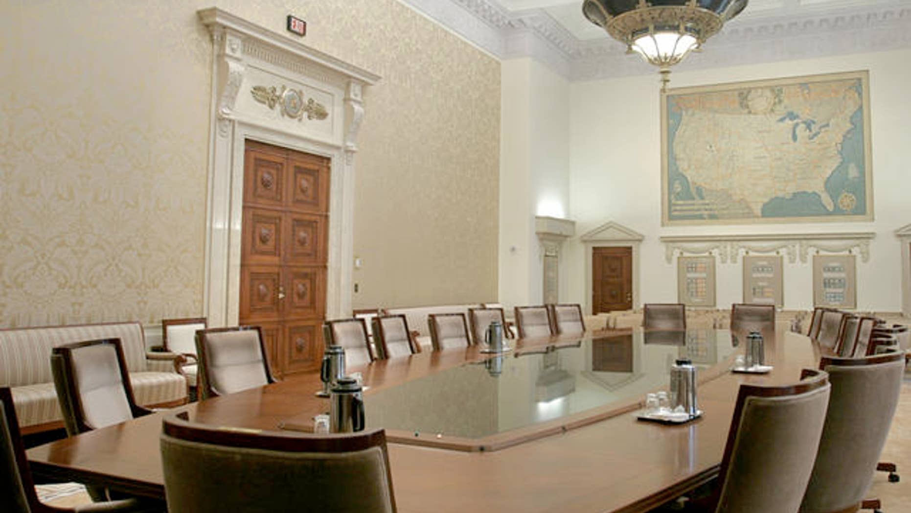 A 1,000-pound brass and glass chandelier festooned with eagles hangs from the 23-foot-high ceiling above the table in the meeting room of the Board of Governors of the Federal Reserve System, usually known as the Fed, in this Tuesday, Jan. 25, 2005 photo. (AP Photo/Lawrence Jackson)