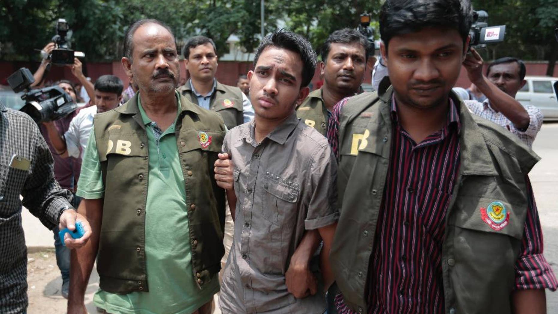 Members of Bangladesh Police Detective Branch escort Mohammed Sumon Hossain in Dhaka, Bangladesh, Thursday, June 16, 2016. Police counter-terrorism chief Monirul Islam told reporters that Hossain is charged with taking part in the October attack on publisher Ahmed Rashid Tutul who worked on books by a prominent atheist writer who was killed in a separate attack. (AP Photo)