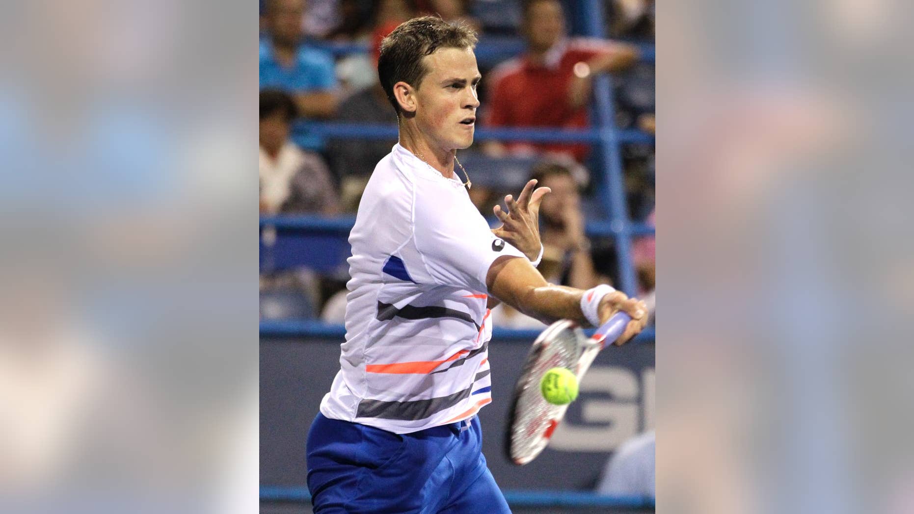 Vasek Pospisil, of Canada, returns the ball to Berdych, of the Czech Republic, at the Citi Open tennis tournament, Thursday, July 31, 2014, in Washington. (AP Photo/Luis M. Alvarez)