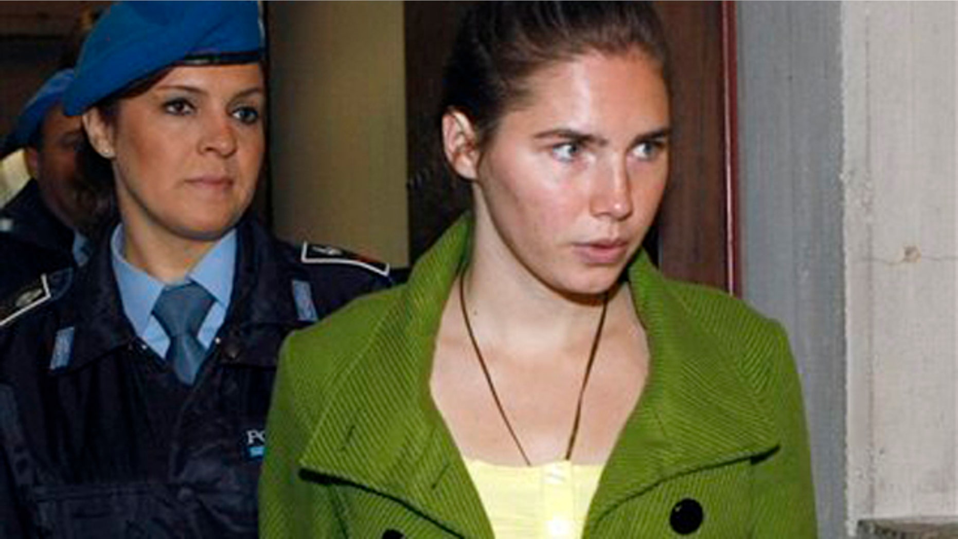 Dec. 4: Amanda Knox is accompanied by a penitentiary police officer prior to a final hearing at the court in Perugia, Italy. Knox was found guilty of murdering her British roommate Meredith Kercher. (AP photo)