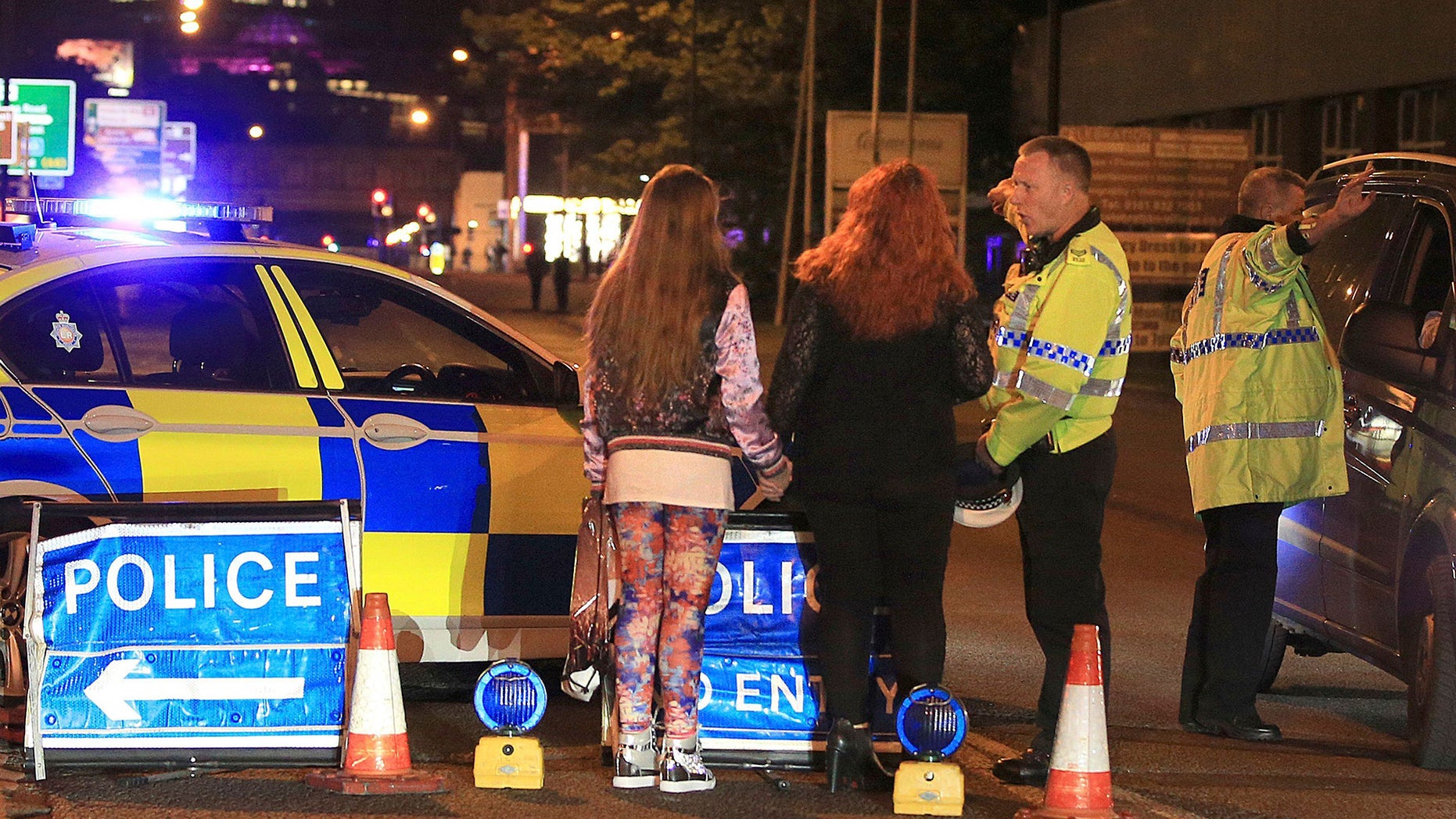 Police work at Manchester Arena after reports of an explosion at the venue during an Ariana Grande gig in Manchester, England Monday, May 22, 2017. Several people have died following reports of an explosion Monday night at an Ariana Grande concert in northern England, police said. A representative said the singer was not injured. (Peter Byrne/PA via AP)