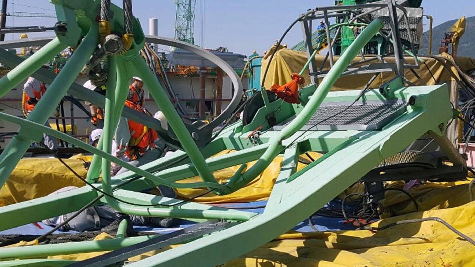 A part of a collapsed crane is seen fallen on the ground at Samsung Heavy Industries' shipyard on Geoje Island, South Korea, Monday, May 1, 2017. Samsung Heavy Industries say a crane has collapsed at its shipyard in South Korea, killing several workers and injuring many more. (Lee Jung-hoon/Yonhap via AP)