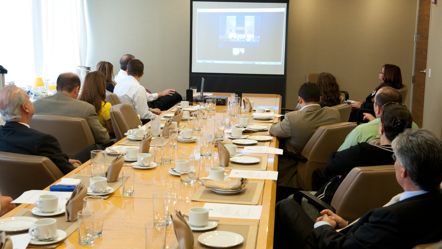 Members of the Cuban American Bar Association in Miami listen via Skype to a briefing in Washington D.C. on human rights violations in Cuba.