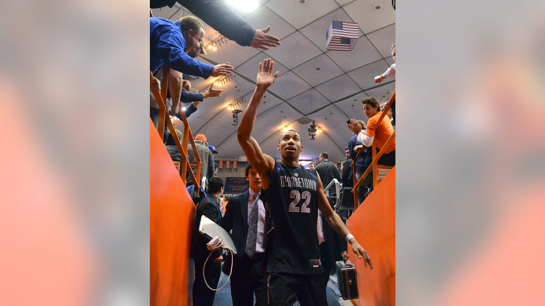 Georgetown's Otto Porter high-fives fans as he exits the court after his team defeated Syracuse 57-46 in an NCAA college basketball game in Syracuse, N.Y., Saturday, Feb. 23, 2013. (AP Photo/Kevin Rivoli)