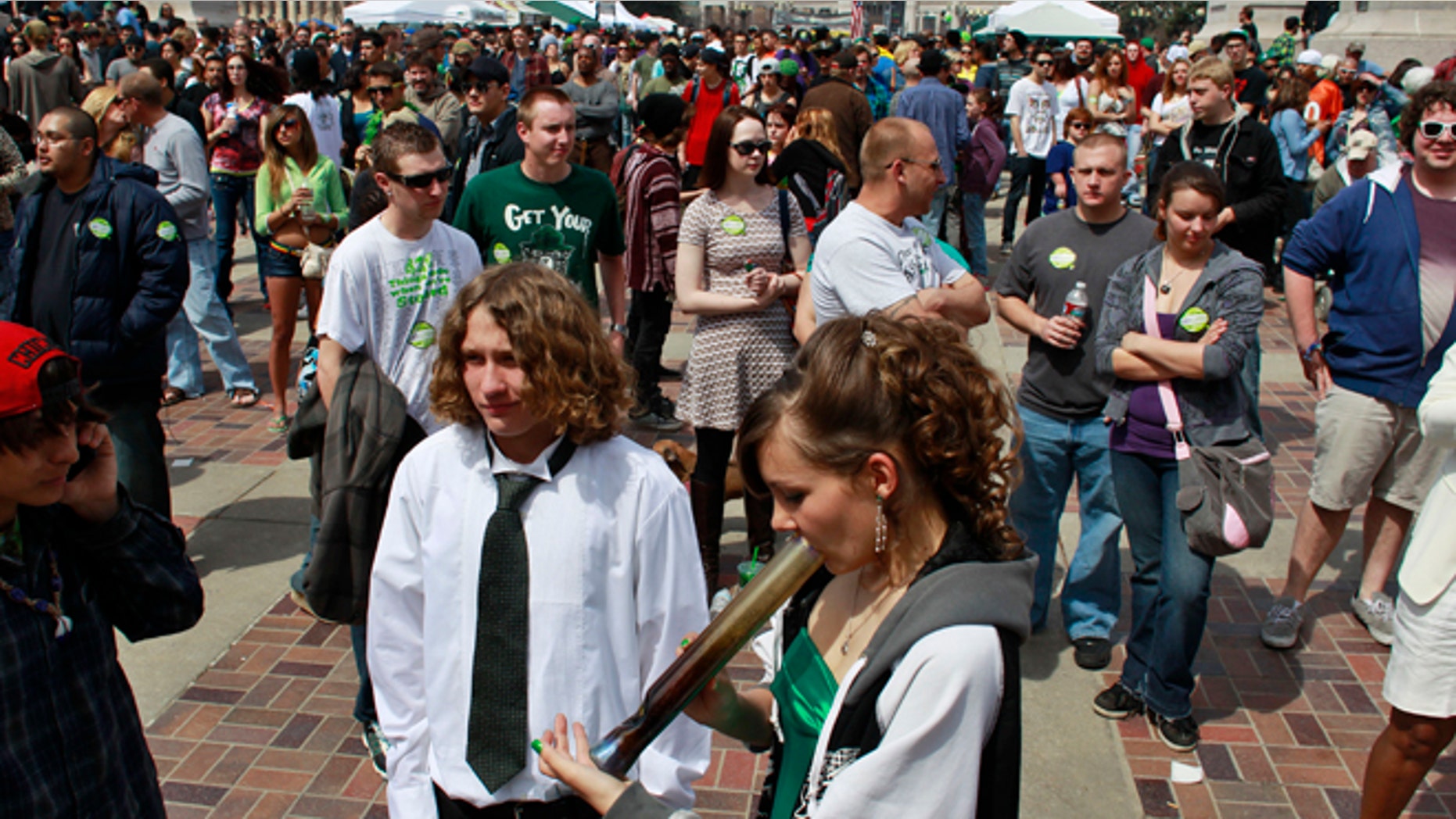 April 20, 2013: Youths smoke marijuana at the Denver 4/20 pro-marijuana rally at Civic Center Park in Denver.