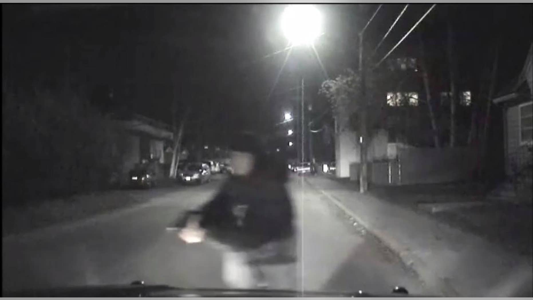 An image from video provided by the Fairbanks Police Department shows shows the suspect police believe abandoned a police car he stole after he shot an officer in Fairbanks, Ak., early Sunday, Oct. 16, 2016. An Alaska police officer was seriously injured in the early morning shooting, according to the Fairbanks police department. The Fairbanks News-Miner reports the officer was flown to Anchorage for treatment. Police are still searching for the shooter. (Fairbanks Police Department via AP)