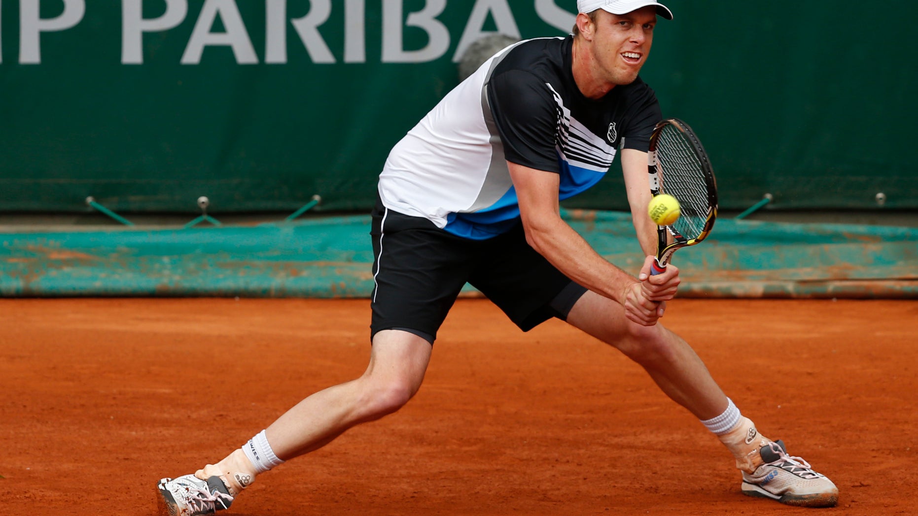 Sam Querrey of the U.S. returns against Gilles Simon of France in their third round match at the French Open tennis tournament, at Roland Garros stadium in Paris, Friday, May 31, 2013. (AP Photo/Petr David Josek)