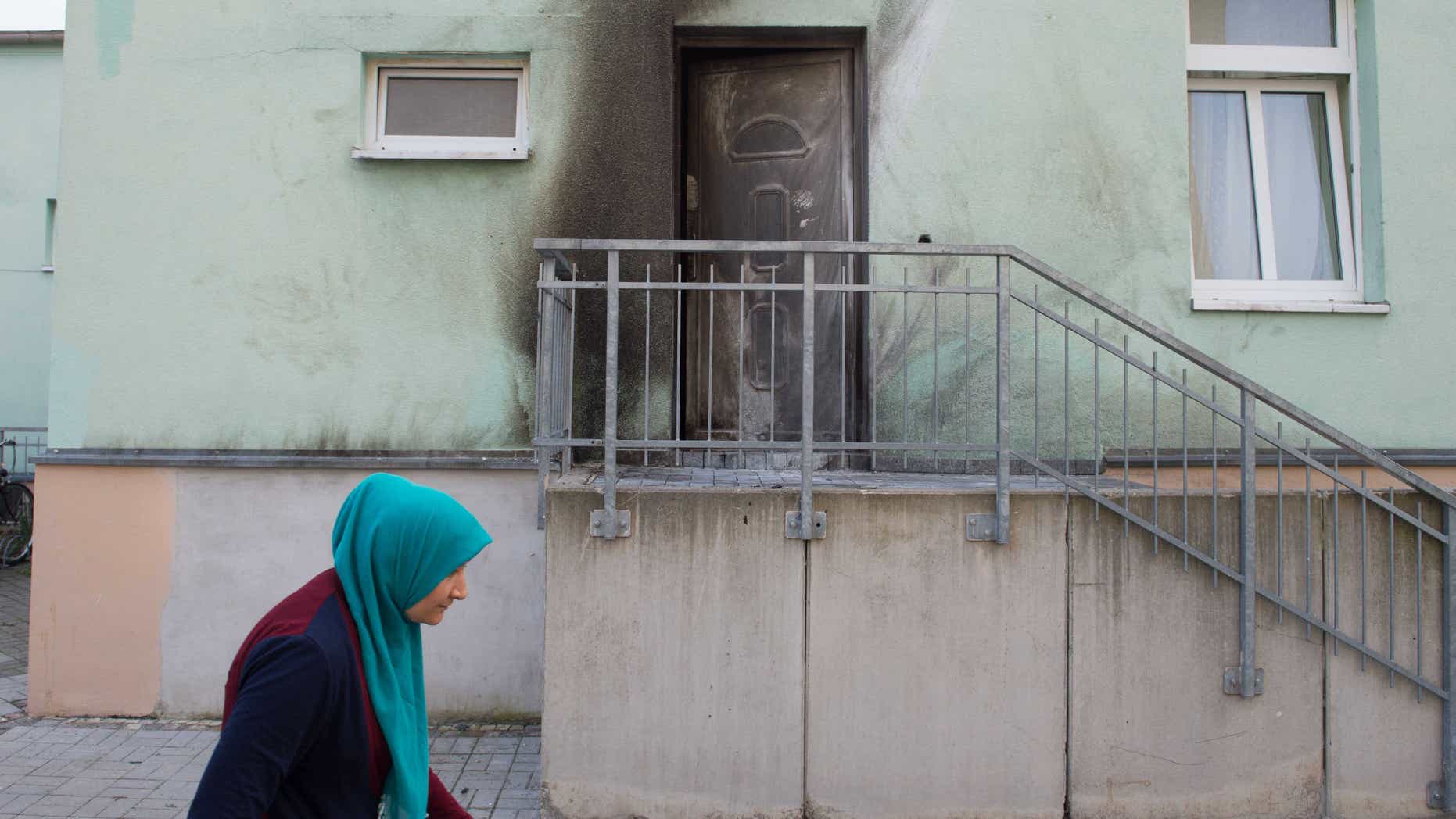 Sept. 27, 2016: A woman walks in front of the entrance of the Fatih Camii mosque in Dresden, Germany.